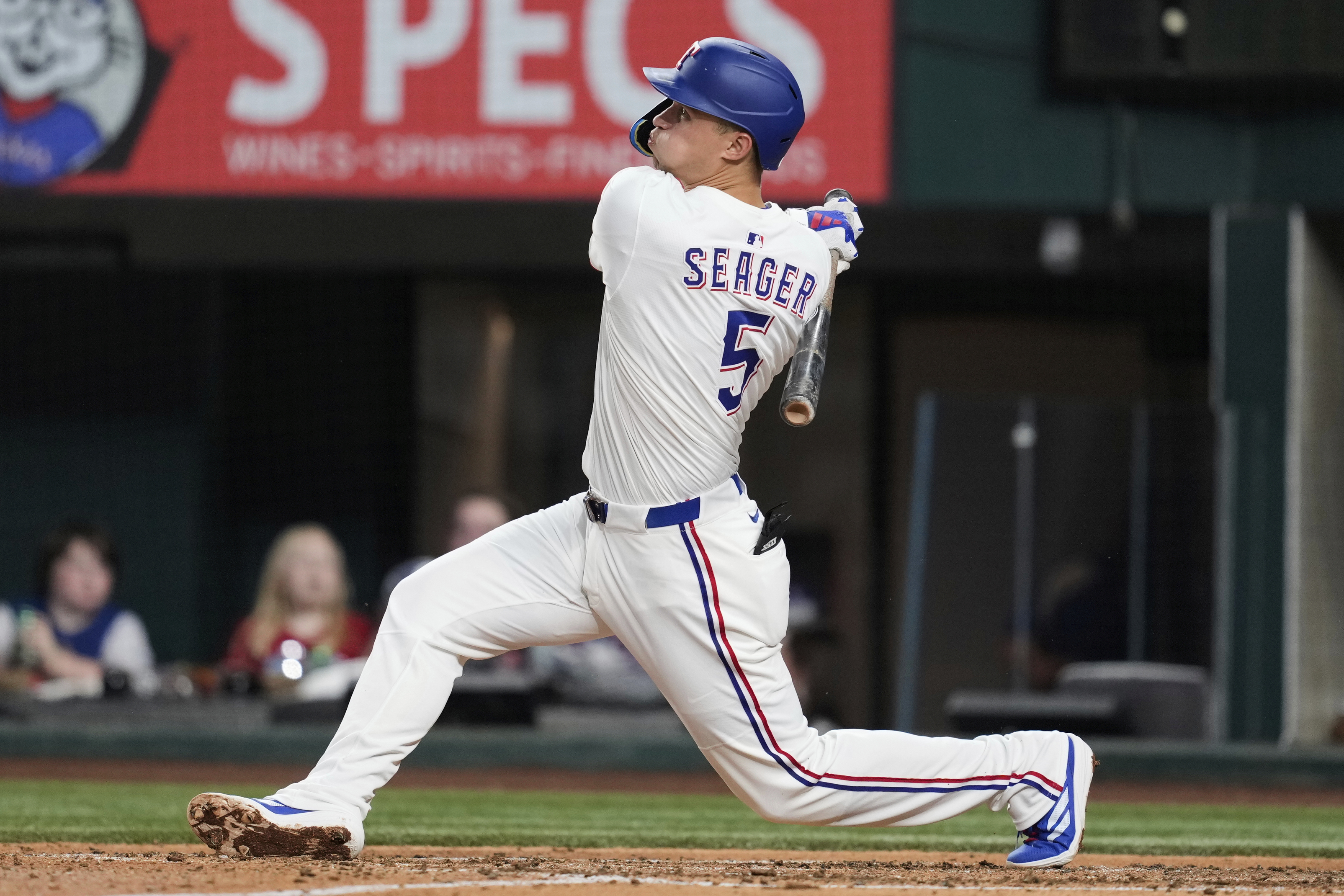 Texas Rangers shortstop Corey Seager follows through on a solo home run swing in the fourth inning of a baseball game against the Los Angeles Angels, Wednesday, Aug. 27, 2025, in Arlington, Texas. 