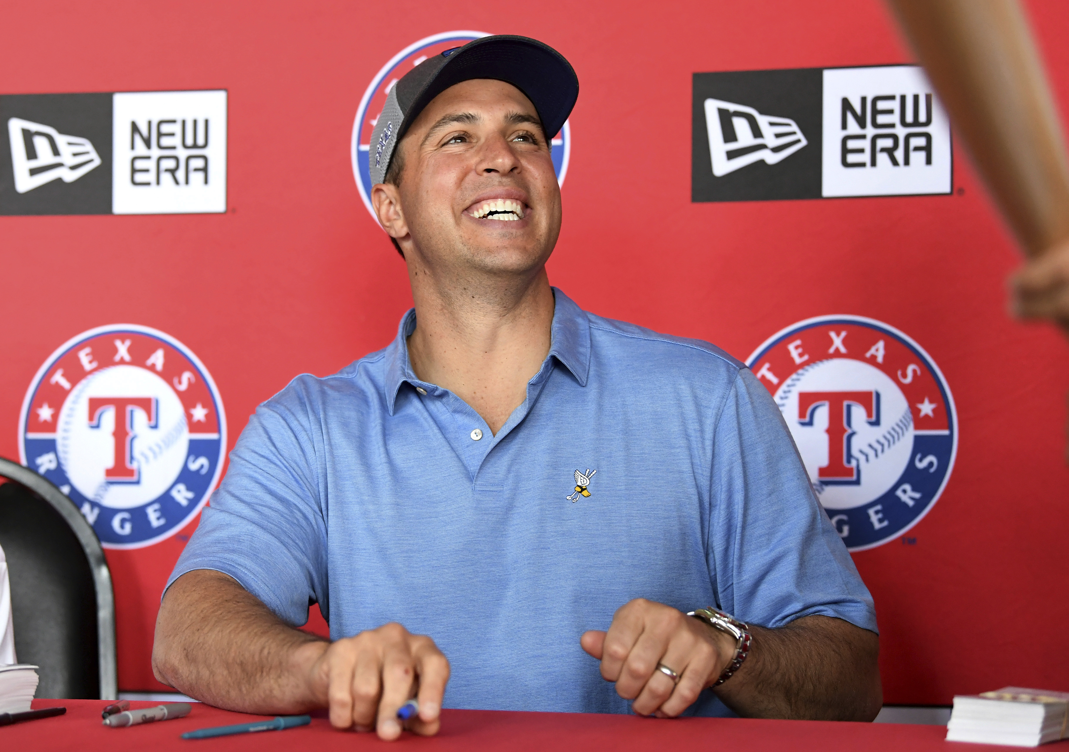 FILE - Former Texas Rangers first baseman Mark Teixeira signs autographs before a baseball game between the Rangers and the Oakland Athletics on April 12, 2019, in Arlington, Texas.