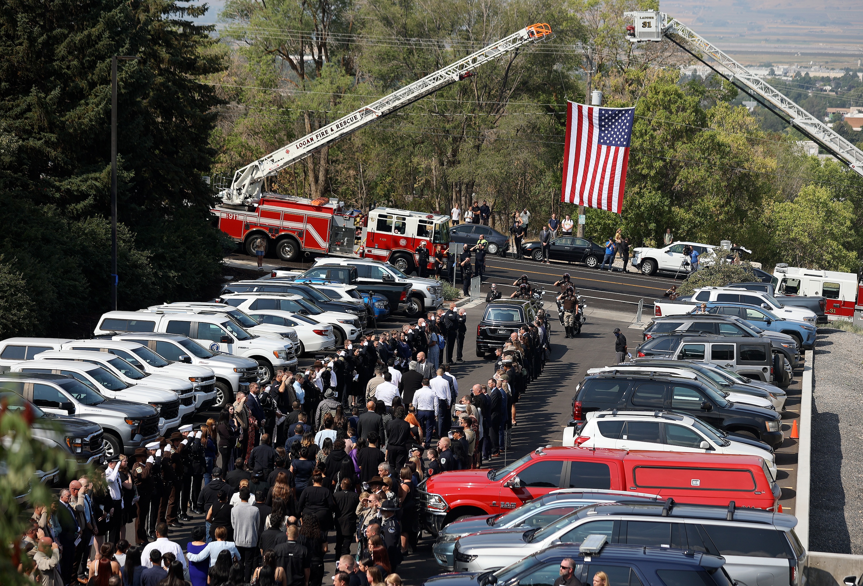 People escort the casket carrying Tremonton-Garland police officer Eric Estrada, who was killed in the line of duty, as he is transported from his funeral at the Dee Glen Spectrum to his interment at the Logan Cemetery in Logan on Thursday.