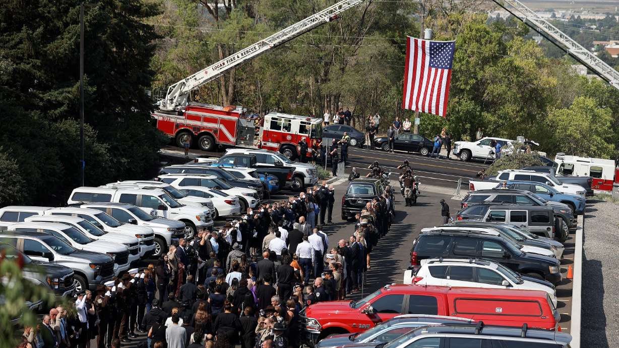 People escort the casket carrying Tremonton-Garland police officer Eric Estrada, who was killed in the line of duty, as he is transported from his funeral at the Dee Glen Spectrum to his interment at the Logan Cemetery in Logan on Thursday.