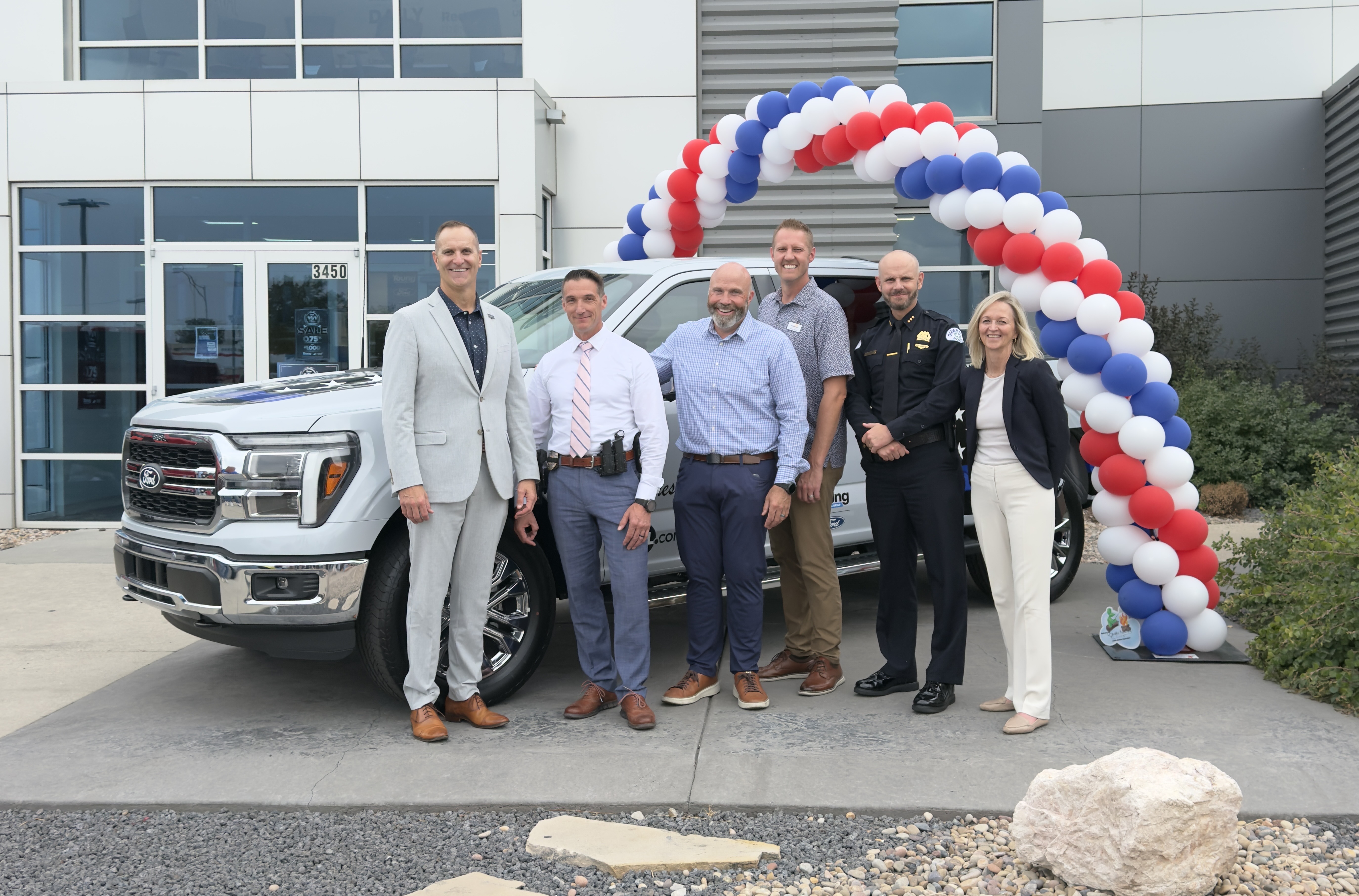 Ogden city detective Cody Wright (second from left) received an all-expenses paid, one year lease on a 2025 Ford F-150 during the event.