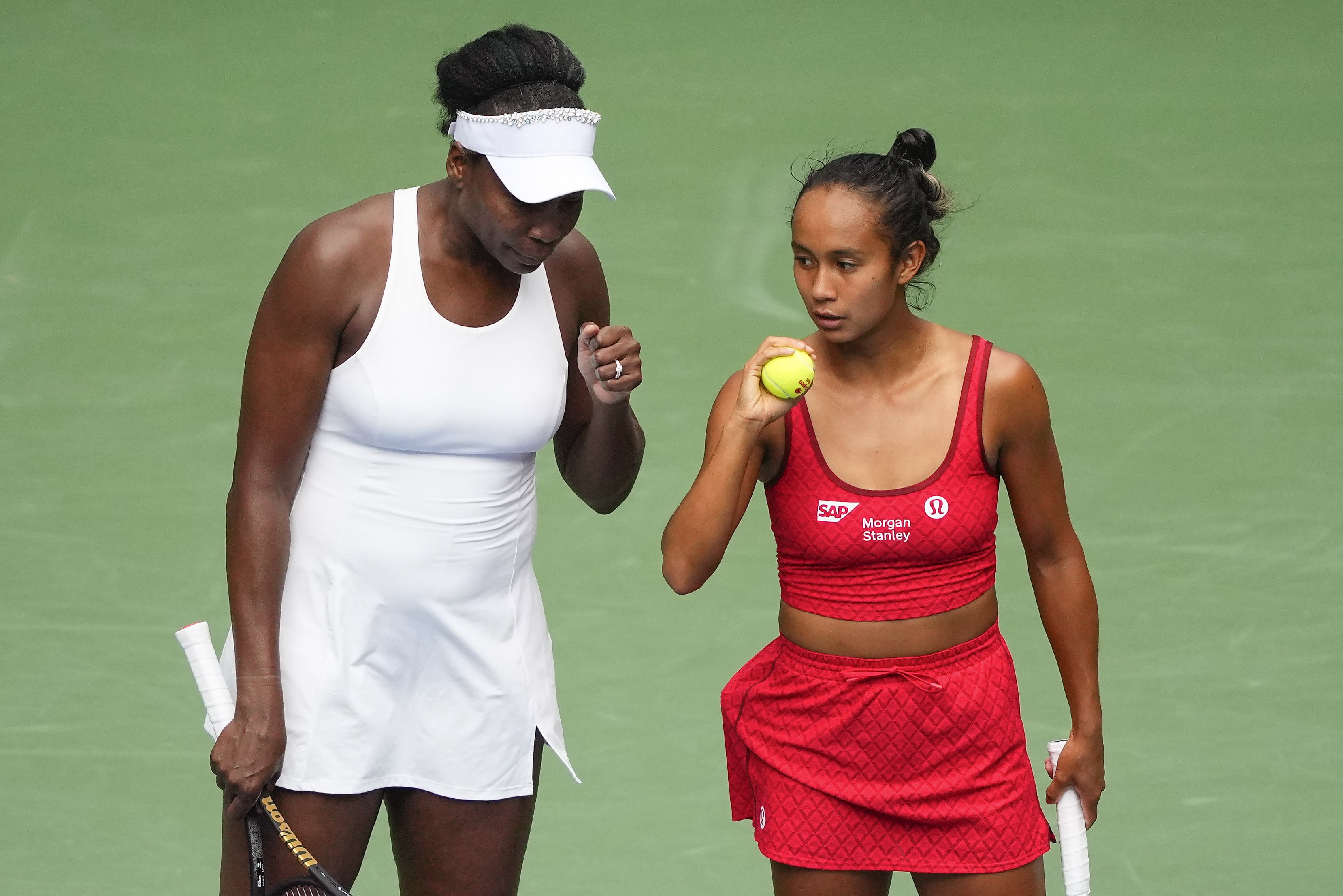Venus Williams, of the United States, left, and Leylah Fernandez, of Canada, talk on the court during a first round women's doubles match against Lyudmyla Kichenok, of the Czech Republic and Ellen Perez, of Australia, during the U.S. Open tennis championships, Thursday, Aug. 28, 2025, in New York. 