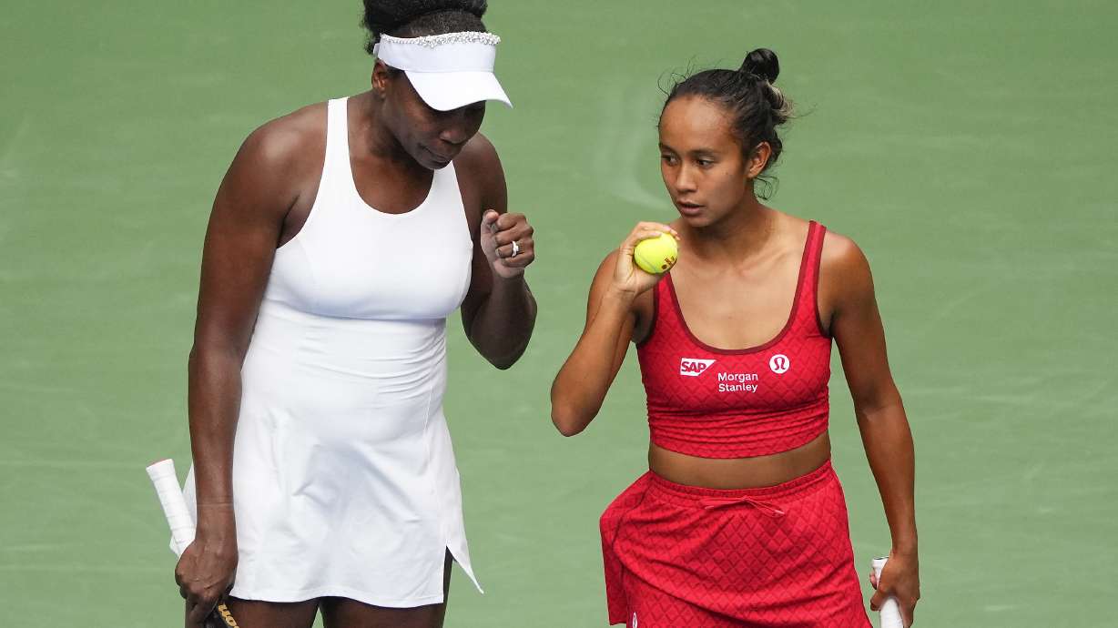 Venus Williams, of the United States, left, and Leylah Fernandez, of Canada, talk on the court during a first round women's doubles match against Lyudmyla Kichenok, of the Czech Republic and Ellen Perez, of Australia, during the U.S. Open tennis championships, Thursday, Aug. 28, 2025, in New York.