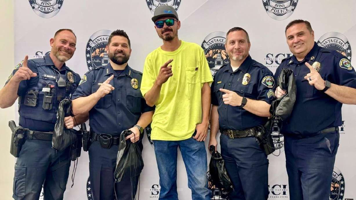 Pictured with St. George police, Jesse Soto, 28, middle, said he wants to help others facing the same struggles he once knew too well.