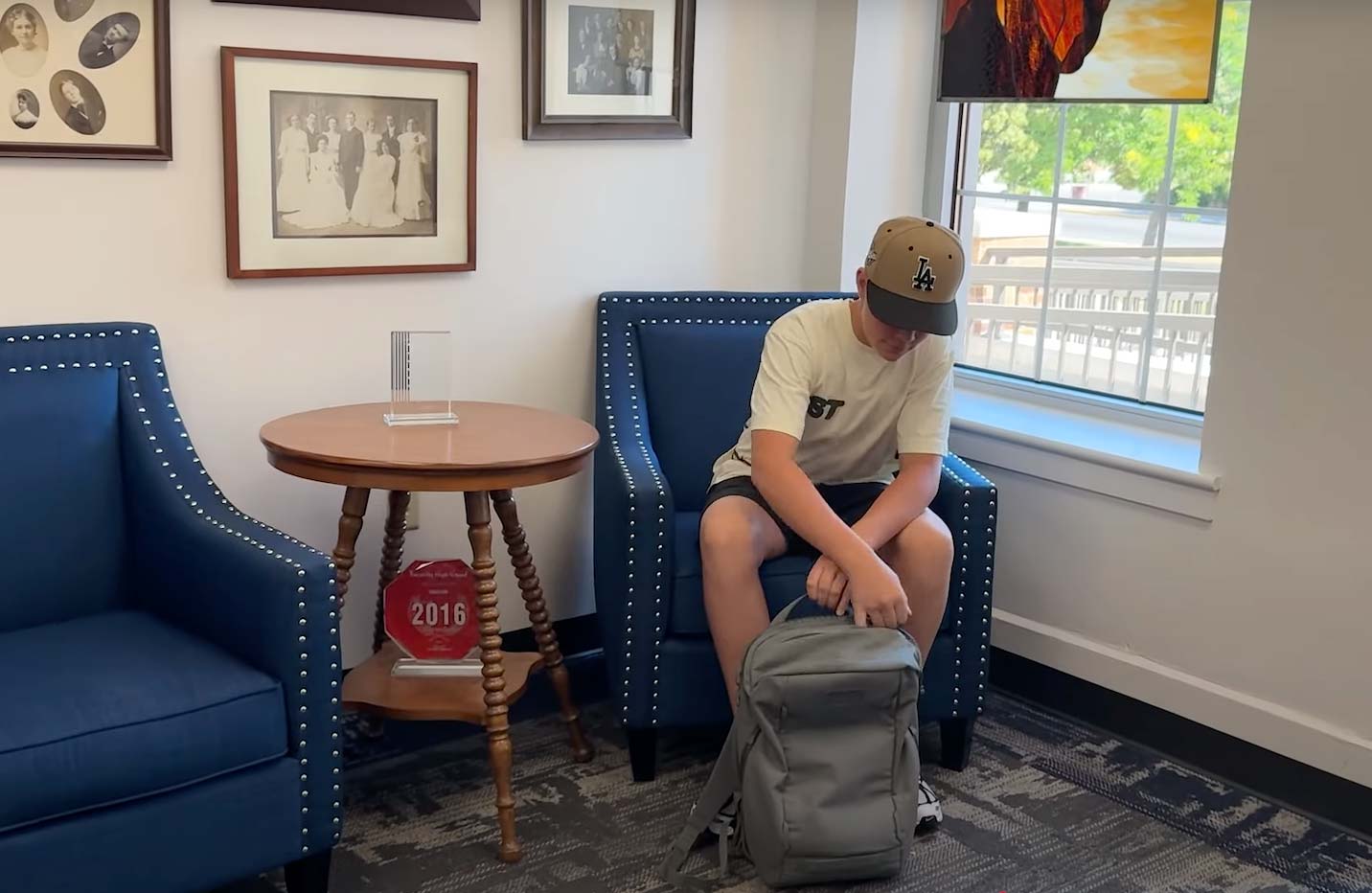 A student accesses his cellphone in the front office, Thursday. Despite the implementation of a new cellphone policy, children can still use it to call their parents in an emergency.