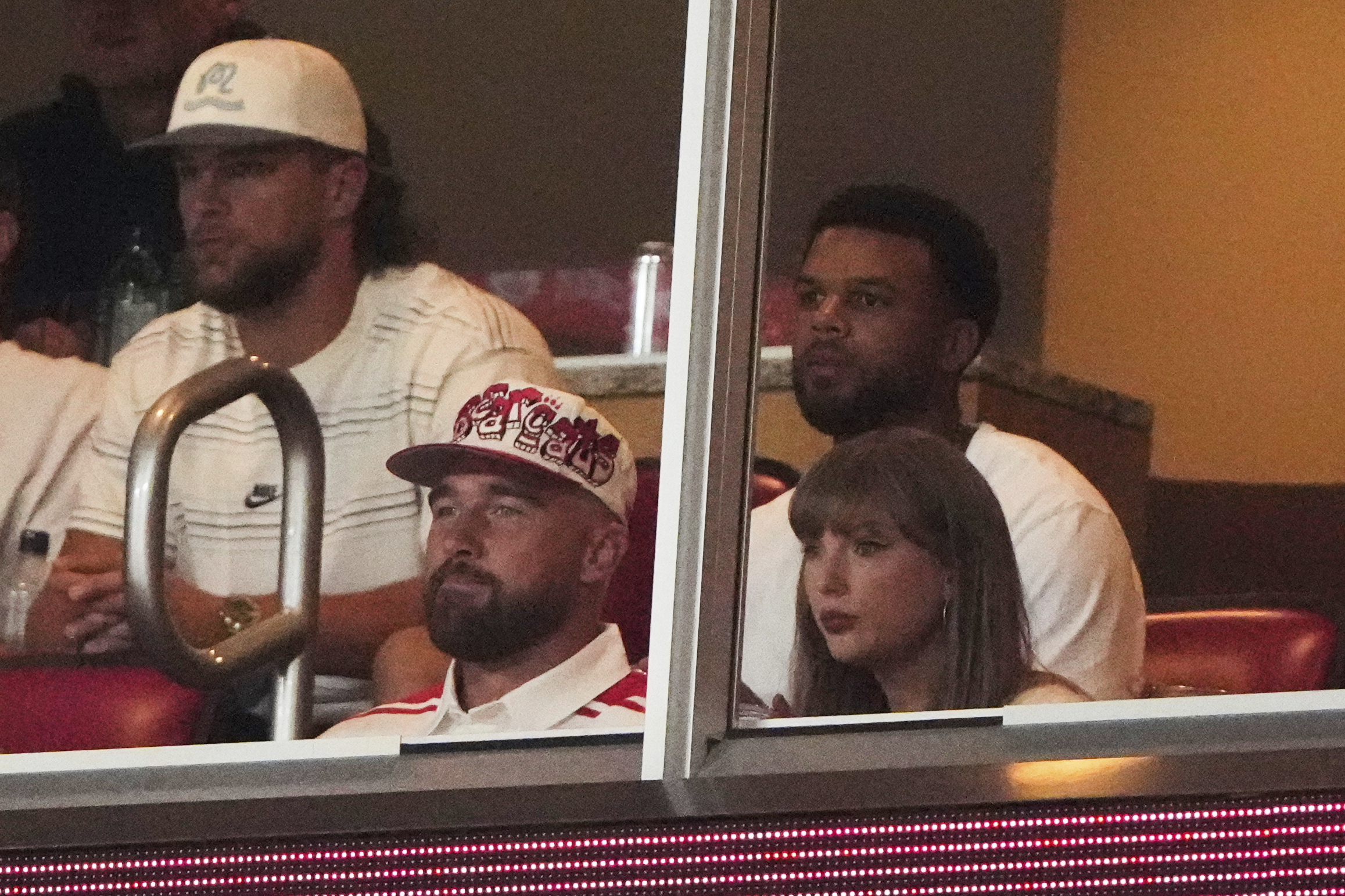 Taylor Swift, front right, sits with fiance Travis Kelce, second from front left, as they watch the first half of an NCAA college football game between Cincinnati and Nebraska, Thursday, Aug. 28, 2025, at Arrowhead Stadium in Kansas City, Mo. 