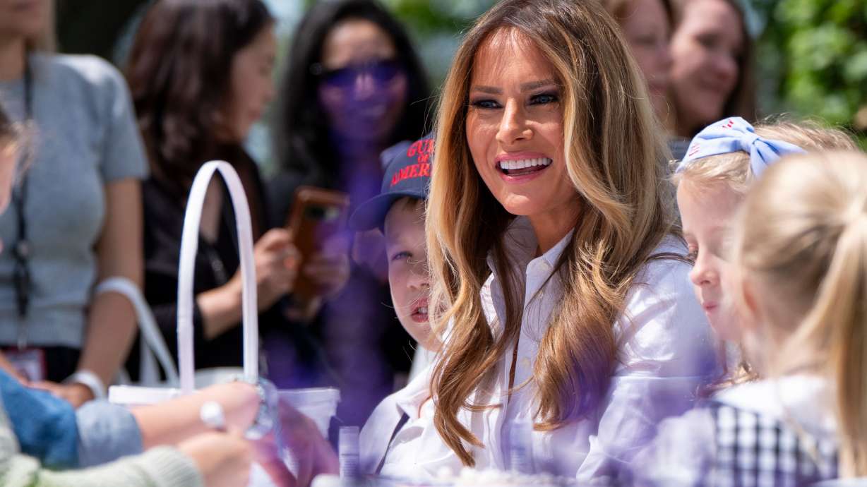 First lady Melania Trump participates in flag decorating during a Take Our Child to Work Day event in the Jacqueline Kennedy Garden at the White House, May 20, in Washington.