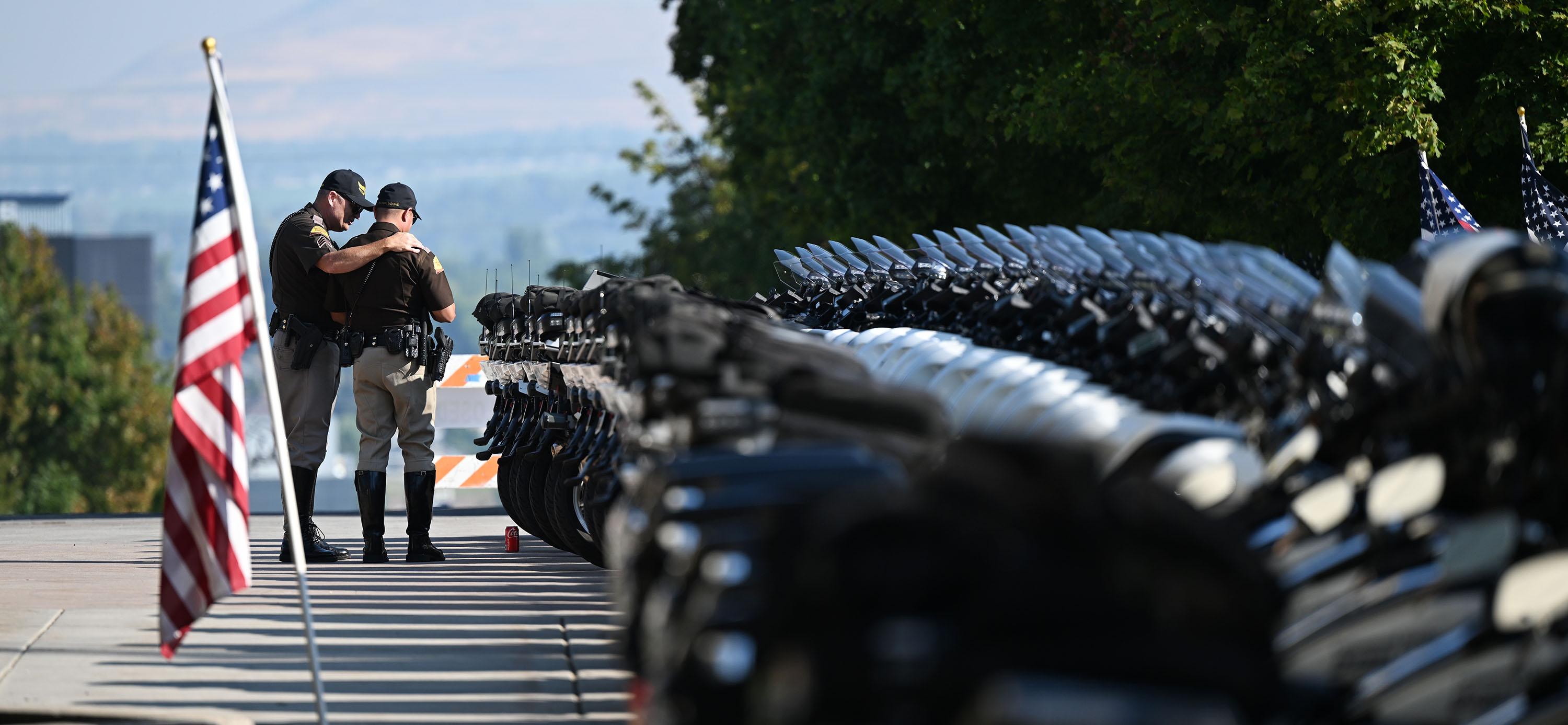 Two UHP troopers talk outside the arena prior to the funeral of Tremonton-Garland Police Sgt. Lee Sorensen at the Dee Glen Smith Spectrum in Logan on Friday.