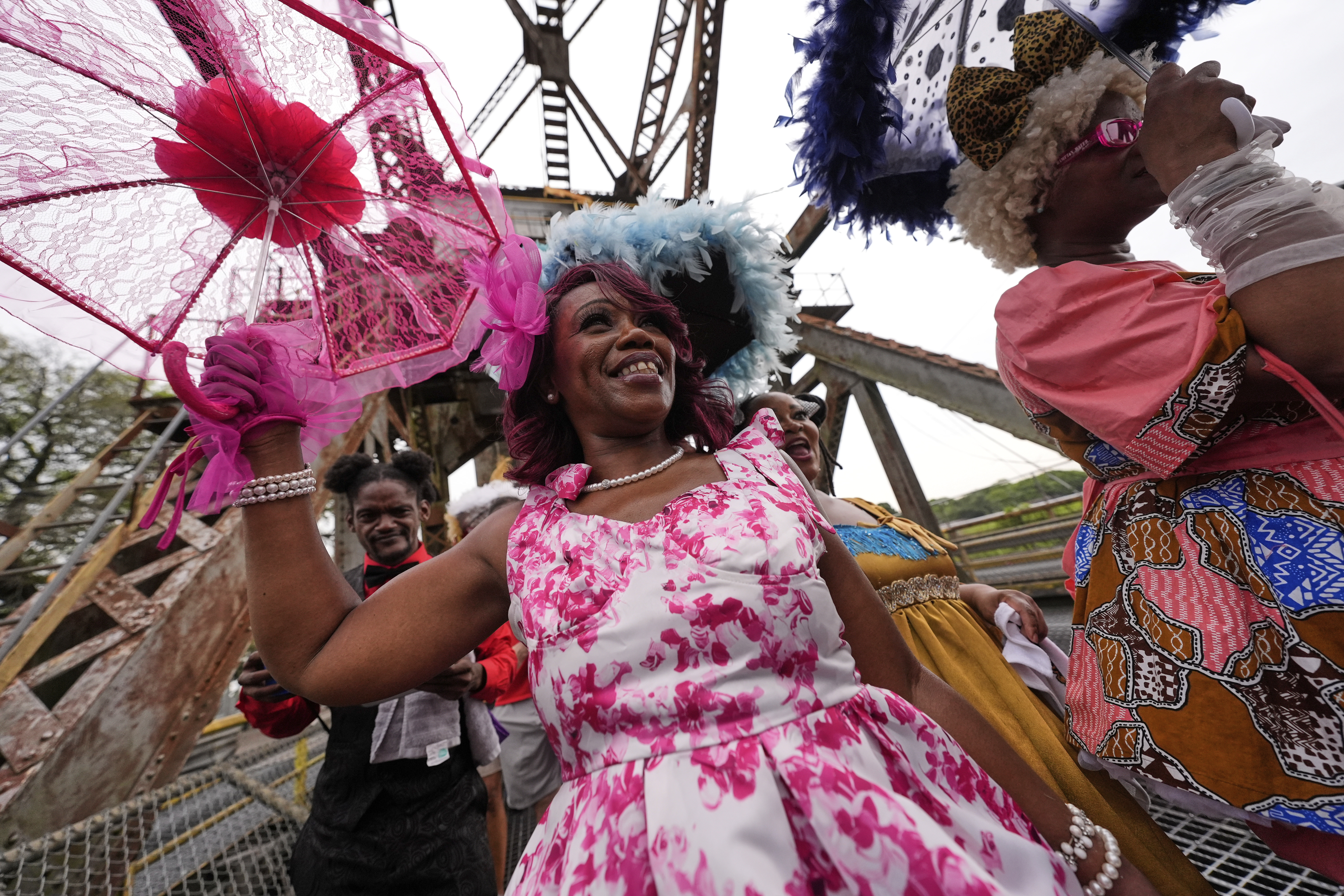 Members of the Original New Orleans Baby Dolls march in a second-line parade to commemorate the 20th anniversary of Hurricane Katrina, in the Lower 9th Ward of New Orleans, Friday. Parades like these are staples of every large-scale New Orleans event.