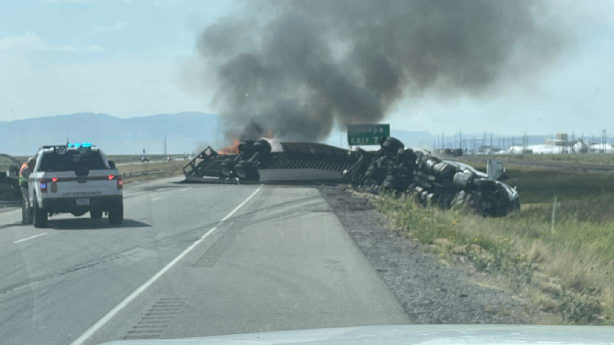 A semitruck transporting Tesla auto parts rolled over on I-80 westbound and caught fire, causing the interstate to close near Skull Valley.