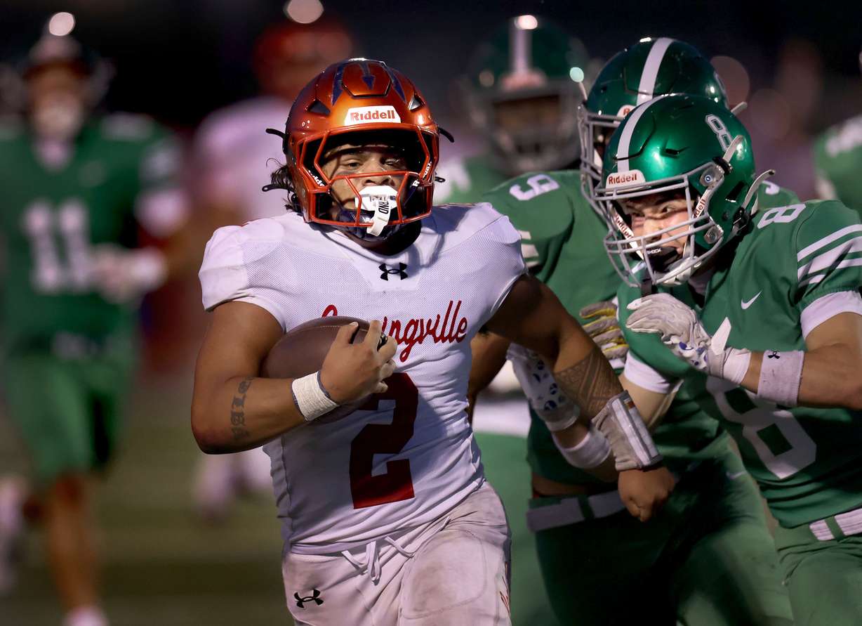 Springville’s Lisiate Valeti (2) runs the ball before getting stoped by Provo’s Brexton Hunter (8) at Provo High on Friday, Aug. 29, 2025.