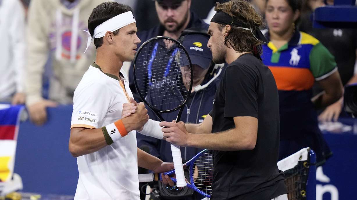 Daniel Altmaier, left, of Germany, is congratulated by Stefanos Tsitsipas, of Greece, after defeating him during the second round of the U.S. Open tennis championships, Thursday, Aug. 28, 2025, in New York.