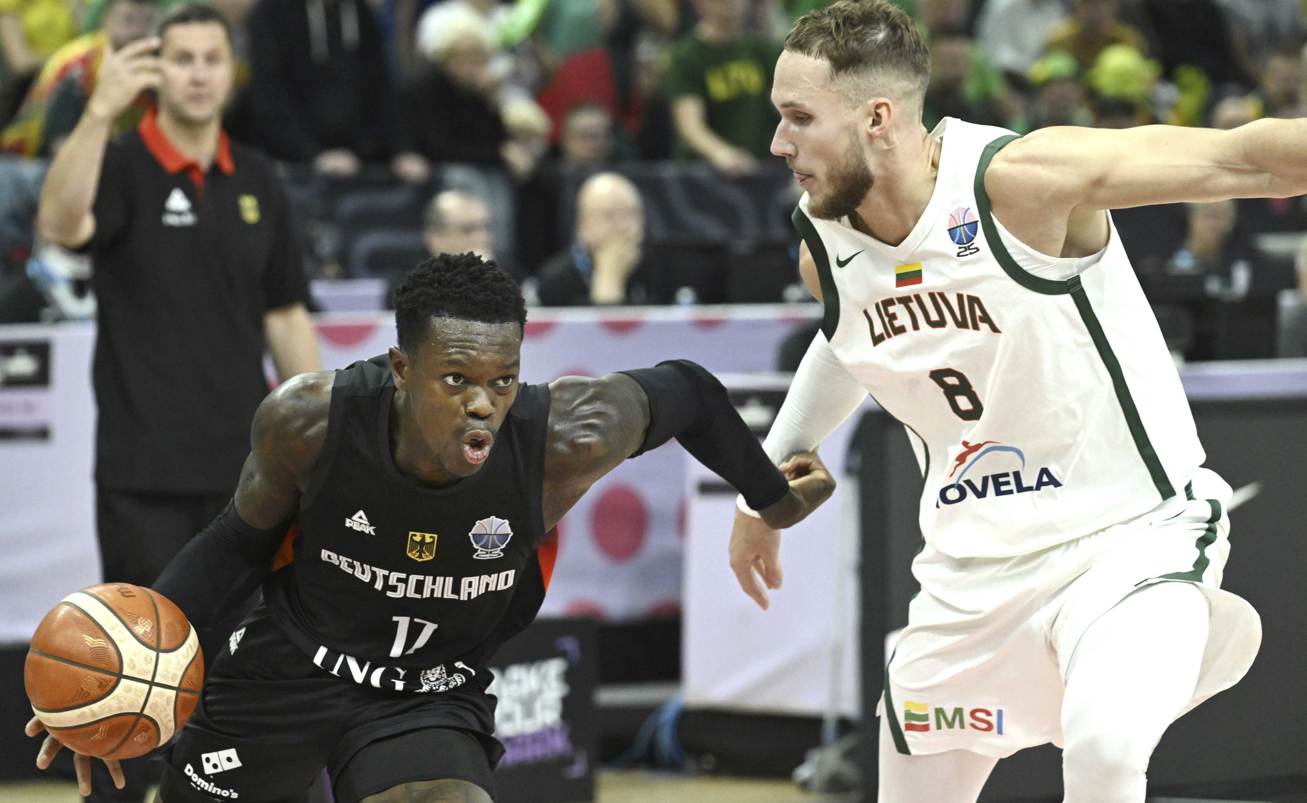 Germany's Dennis Schroeder, left, and Lithuania's Tadas Sedekerskis in action during the basketball FIBA EuroBasket 2025 group B match between Lithuania and Germany in Tampere, Finland, Saturday Aug. 30, 2025. 
