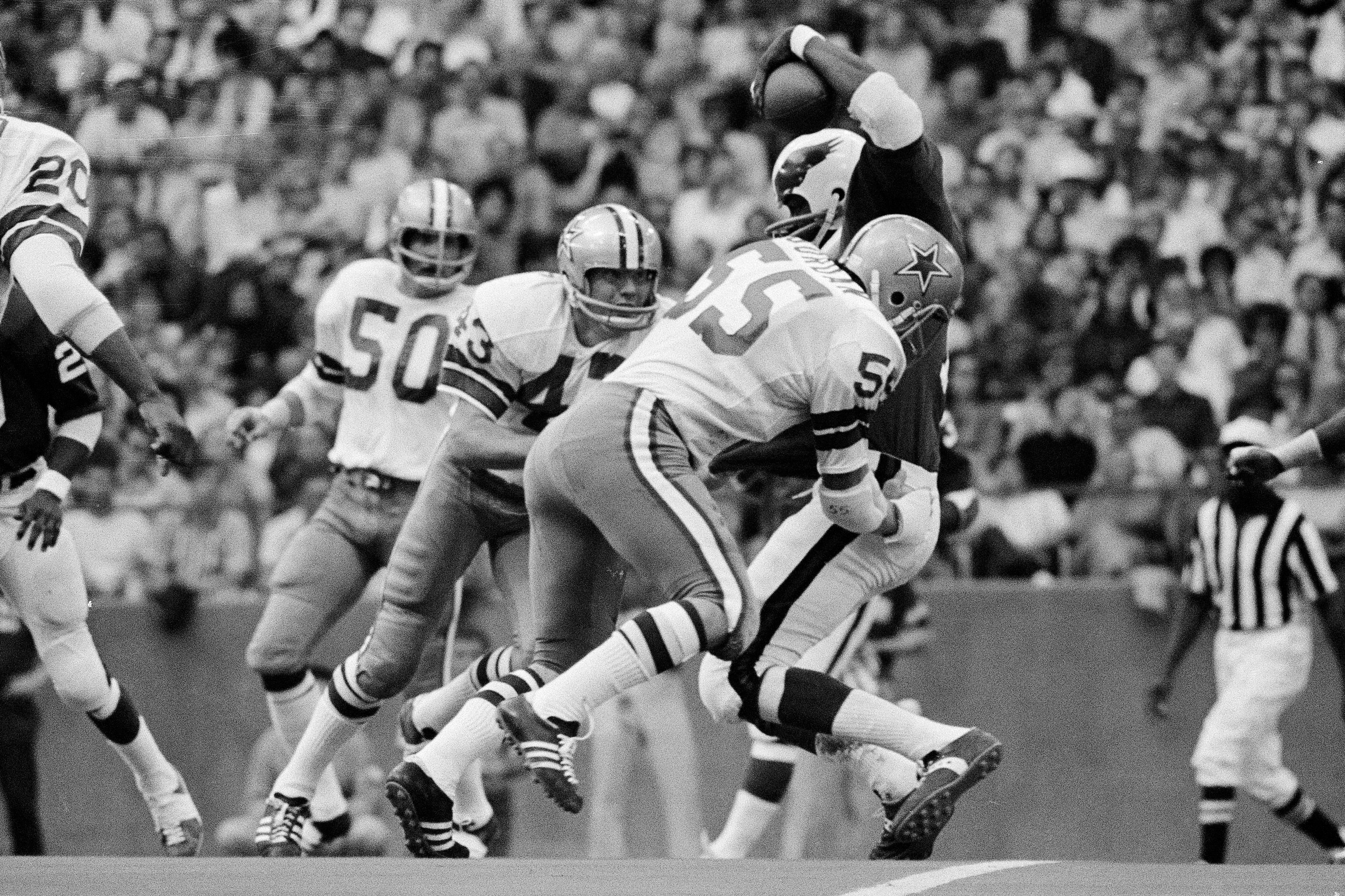 FILE - Philadelphia Eagles wide receiver Harold Carmichael is swarmed by the Dallas Cowboys defense, including linebacker Lee Roy Jordan (55) during third period of an NFL football game in Irving, Texas, Nov. 15, 1971. 