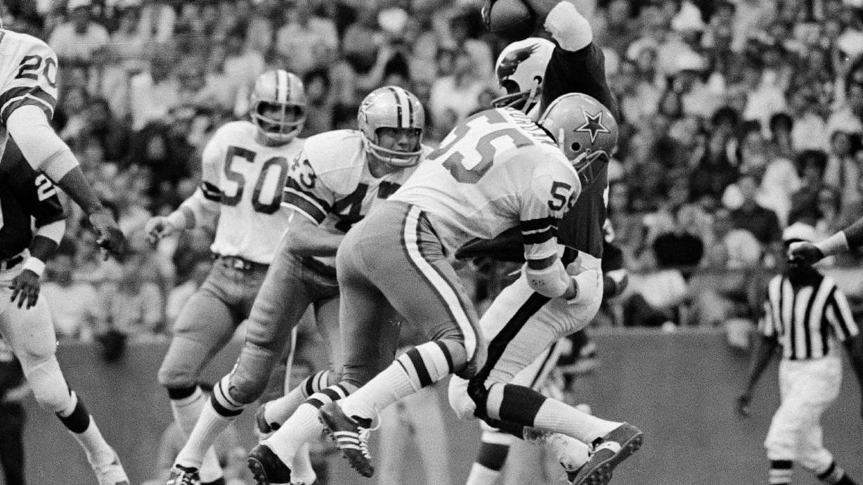 FILE - Philadelphia Eagles wide receiver Harold Carmichael is swarmed by the Dallas Cowboys defense, including linebacker Lee Roy Jordan (55) during third period of an NFL football game in Irving, Texas, Nov. 15, 1971.