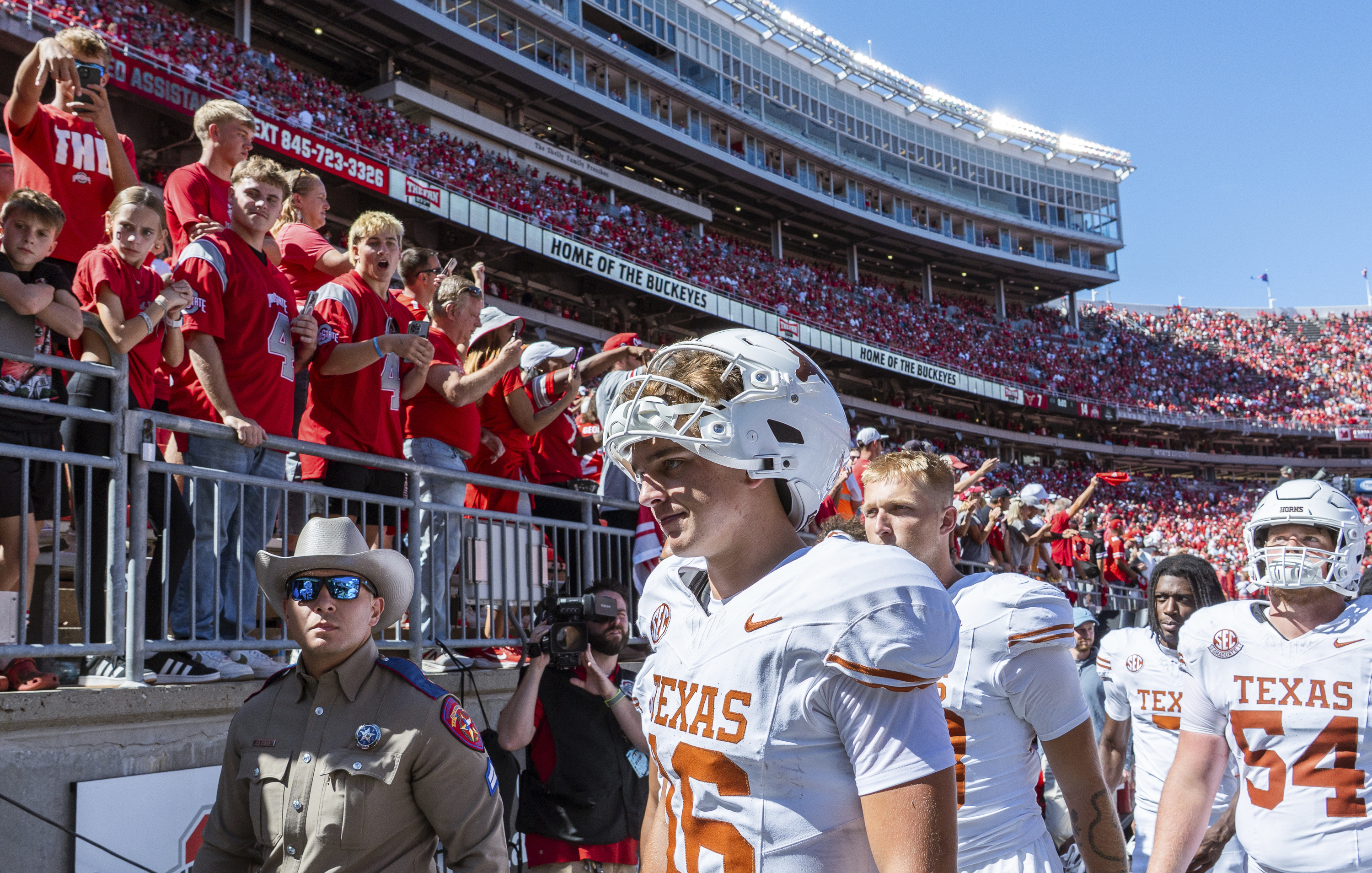 Texas quarterback Arch Manning (16) walks past Ohio State fans flashing "Horns Down" as he heads to the locker room after an NCAA college football game against Ohio State, Saturday, Aug. 30, 2025., in Columbus, Ohio. 