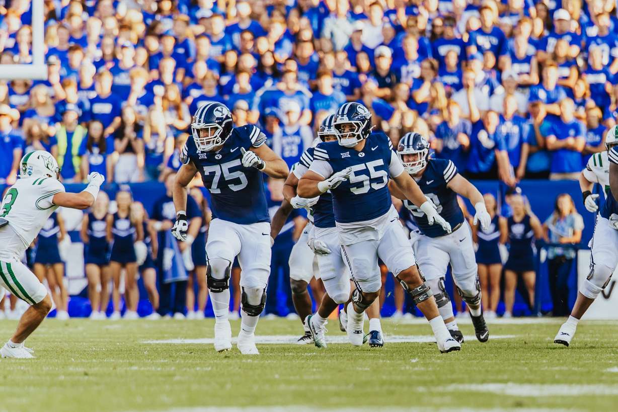 BYU's Andrew Genty and Austin Leausa block downfield during the first half of an NCAA college football game, Saturday, Aug. 30, 2025 at LaVell Edwards Stadium in Provo, Utah.