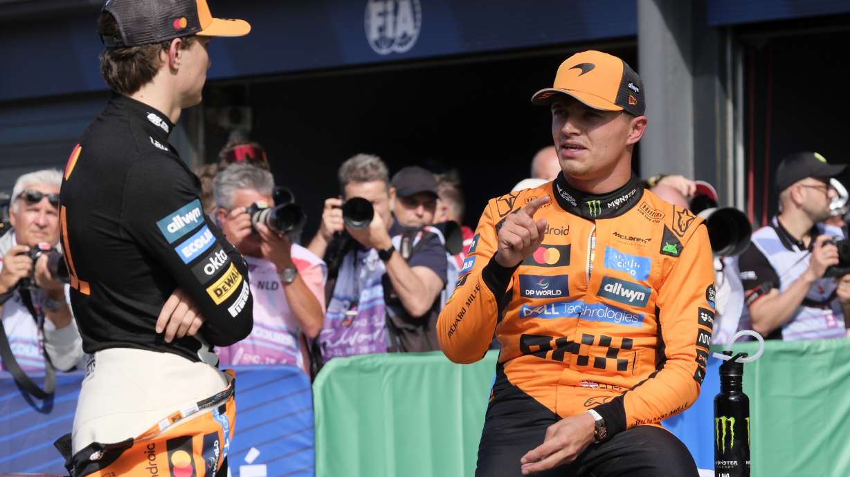 McLaren driver Lando Norris of Britain, right, talks to McLaren driver Oscar Piastri of Australia after the qualifying session ahead of the Formula One Dutch Grand Prix at the Zandvoort racetrack in Zandvoort, Netherlands, Saturday, Aug. 30, 2025.