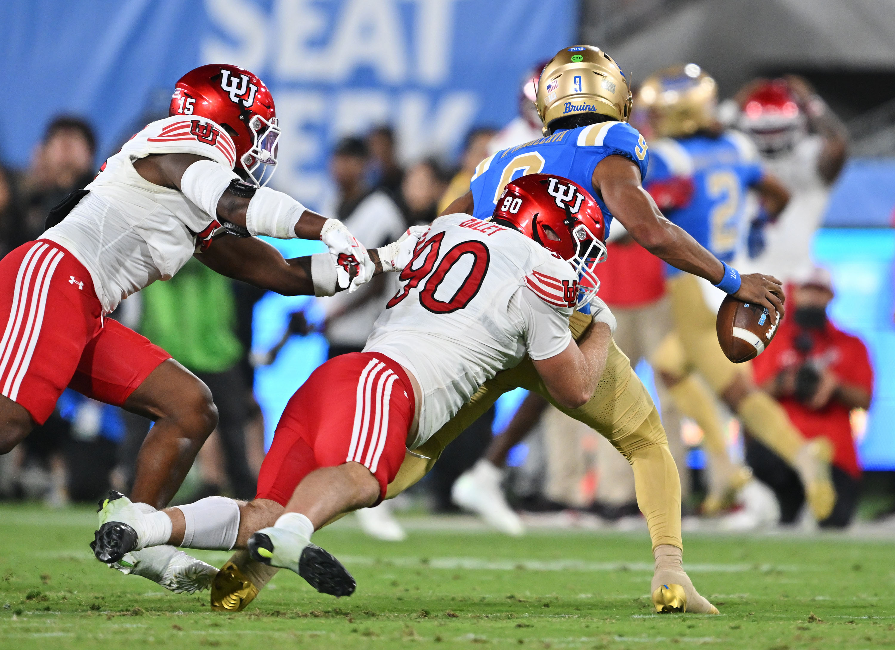 Utah Utes defensive end Lance Holtzclaw (15) and Utah Utes defensive end John Henry Daley (90) chase down UCLA Bruins quarterback Nico Iamaleava (9) as they play at the Rose Bowl in Pasadena on Saturday, Aug. 30, 2025. Utah won 43-10.