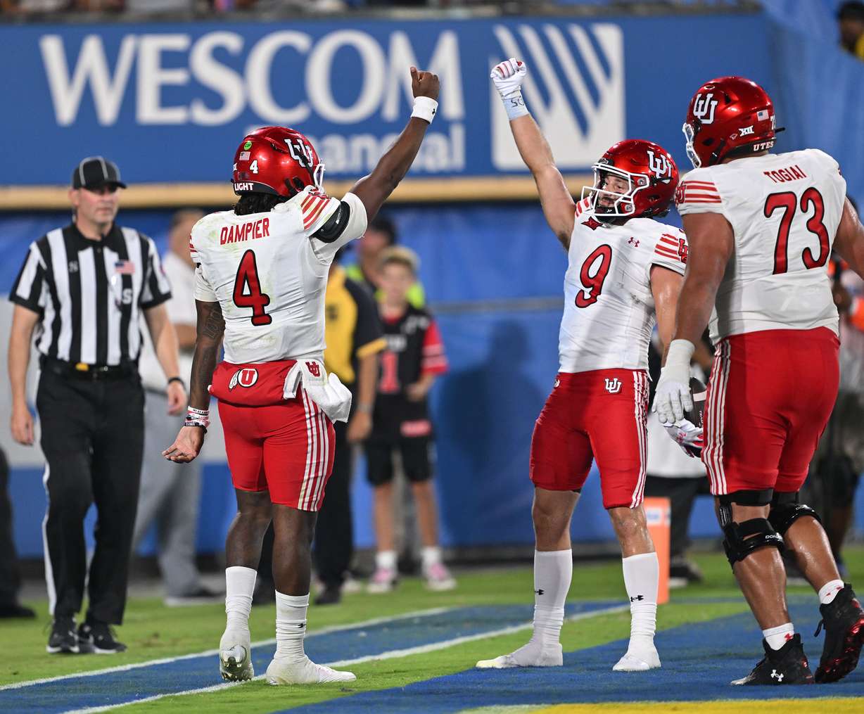 Utah Utes quarterback Devon Dampier (4) and Utah Utes wide receiver Ryan Davis (9) celebrate after a Dampier touchdown as Utah and UCLA play at the Rose Bowl in Pasadena on Saturday, Aug. 30, 2025. Utah won 43-10.