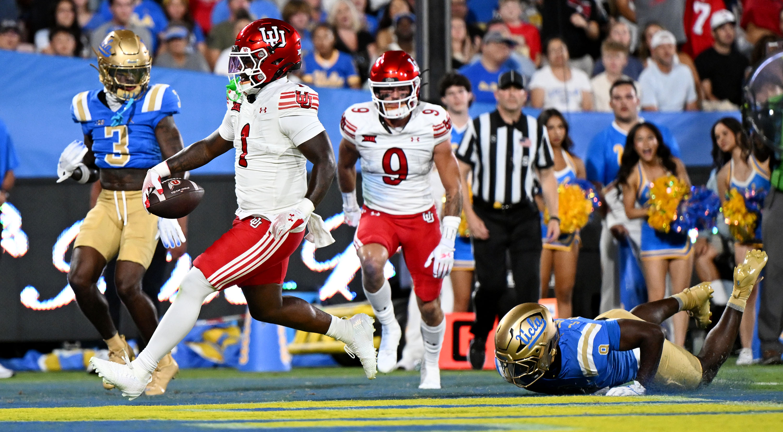 Utah Utes running back Wayshawn Parker (1) runs in for a touchdown ahead of UCLA Bruins linebacker Jalen Woods (9) as Utah and UCLA play at the Rose Bowl in Pasadena, Calif., on Saturday, Aug. 30, 2025.