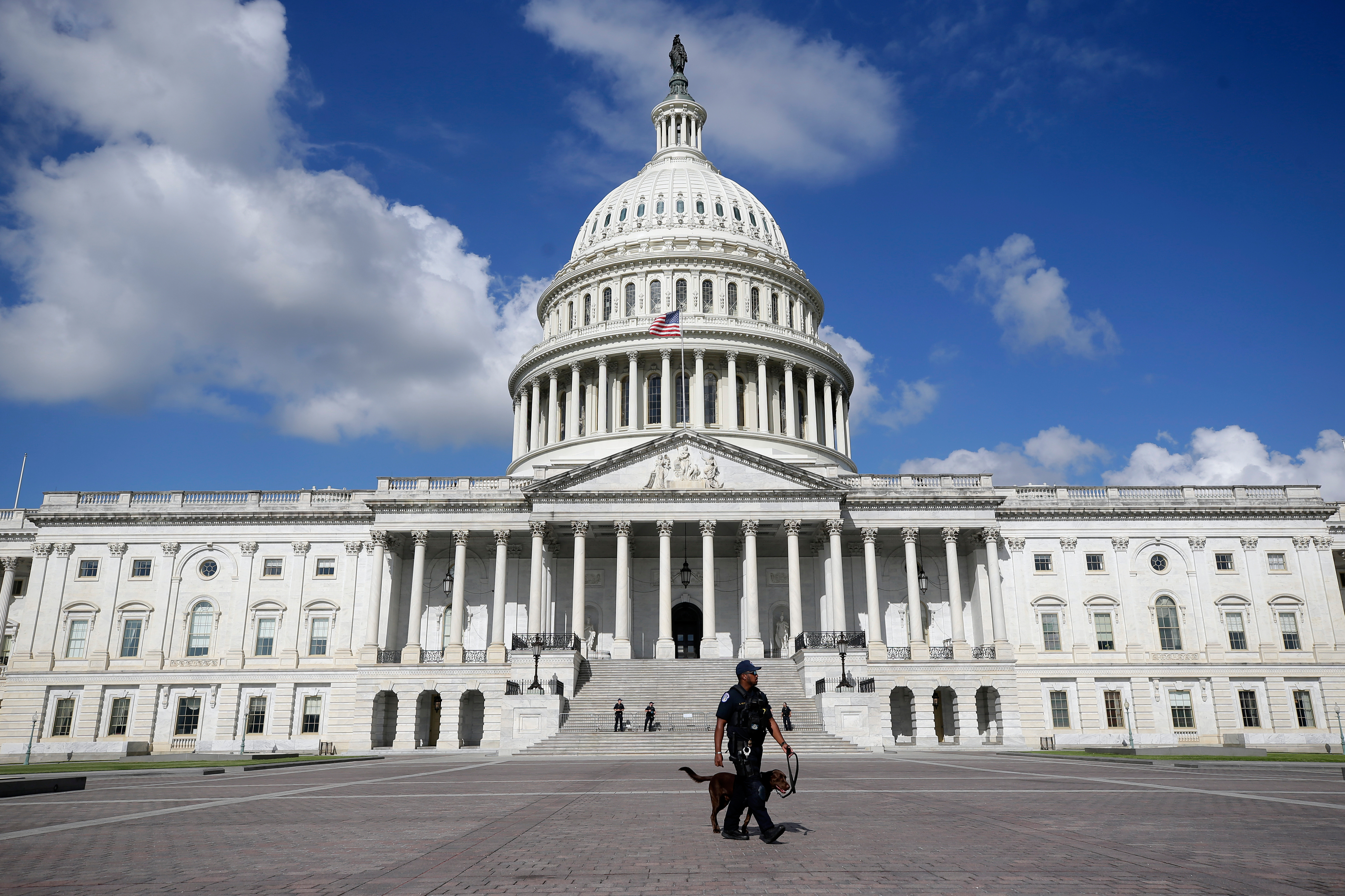 A U.S. Capitol Police officer in front of the Capitol, Aug. 22, in Washington. The killing of Charlie Kirk has lawmakers reconsidering their personal security.