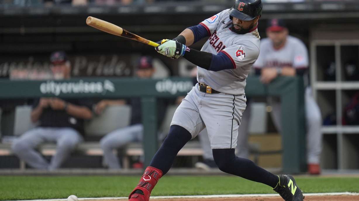 Cleveland Guardians' Carlos Santana hits a two-run double during the first inning of a baseball game against the Chicago White Sox, Friday, Aug. 8, 2025, in Chicago.