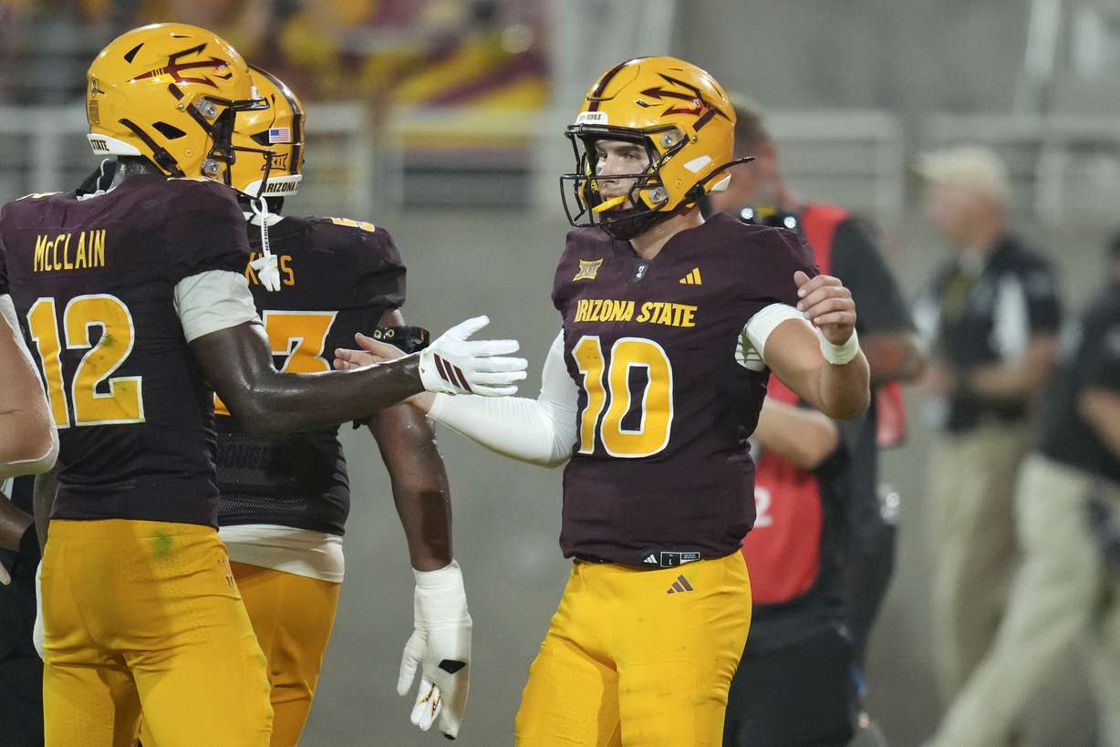 Arizona State quarterback Sam Leavitt (10) celebrates his touchdown run against Northern Arizona with Arizona State wide receiver Malik McClain (12) during the second half of an NCAA football game Saturday, Aug. 30, 2025, in Tempe, Ariz.