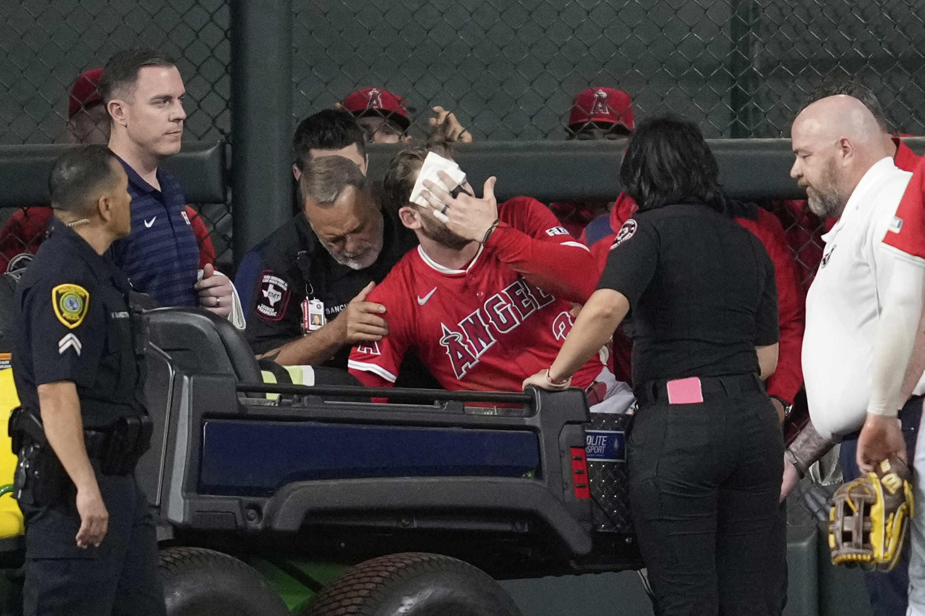 Los Angeles Angels left fielder Taylor Ward, center, is treated for injury during the eighth inning of a baseball game against the Houston Astros in Houston, Sunday, Aug. 31, 2025. 