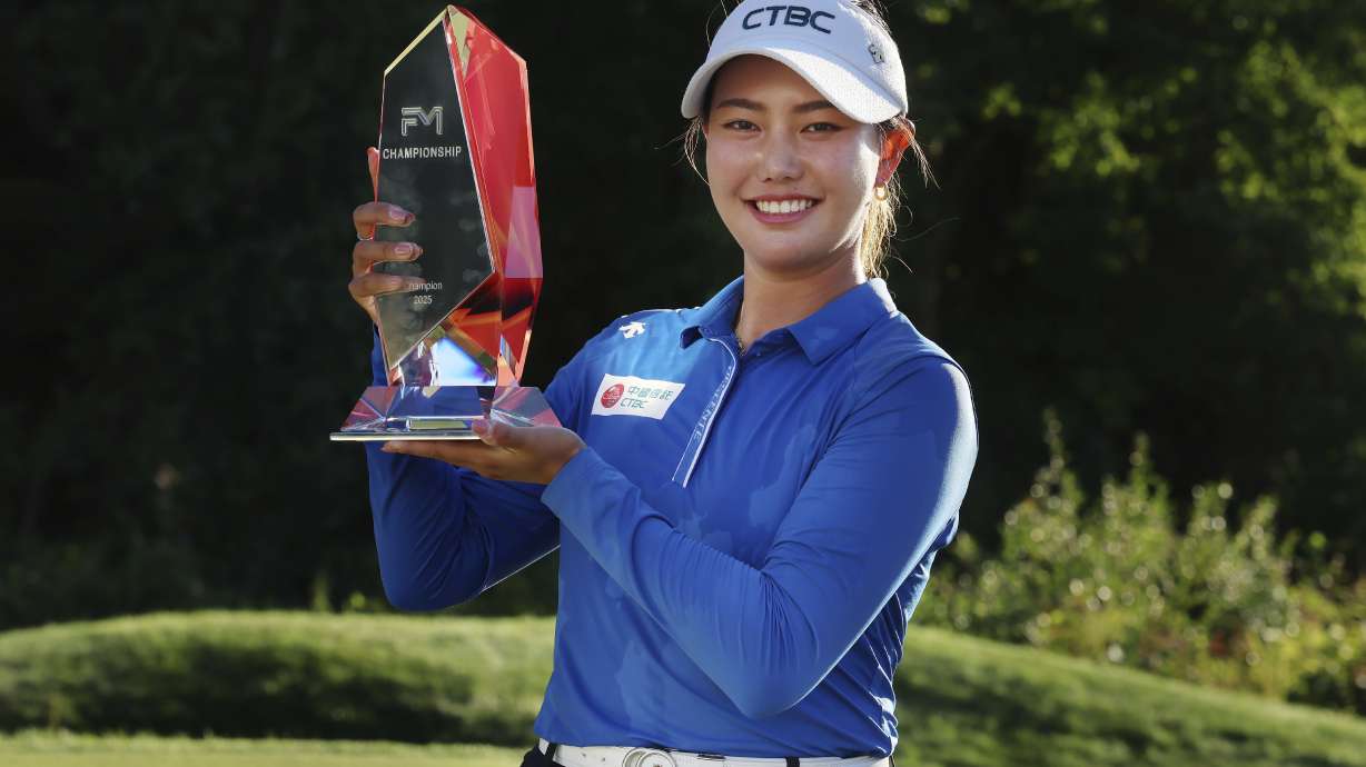Miranda Wang, of China, holds the trophy after winning the FM Championship LPGA golf tournament at TPC Boston, Sunday, Aug. 31, 2025, in Norton, Mass.