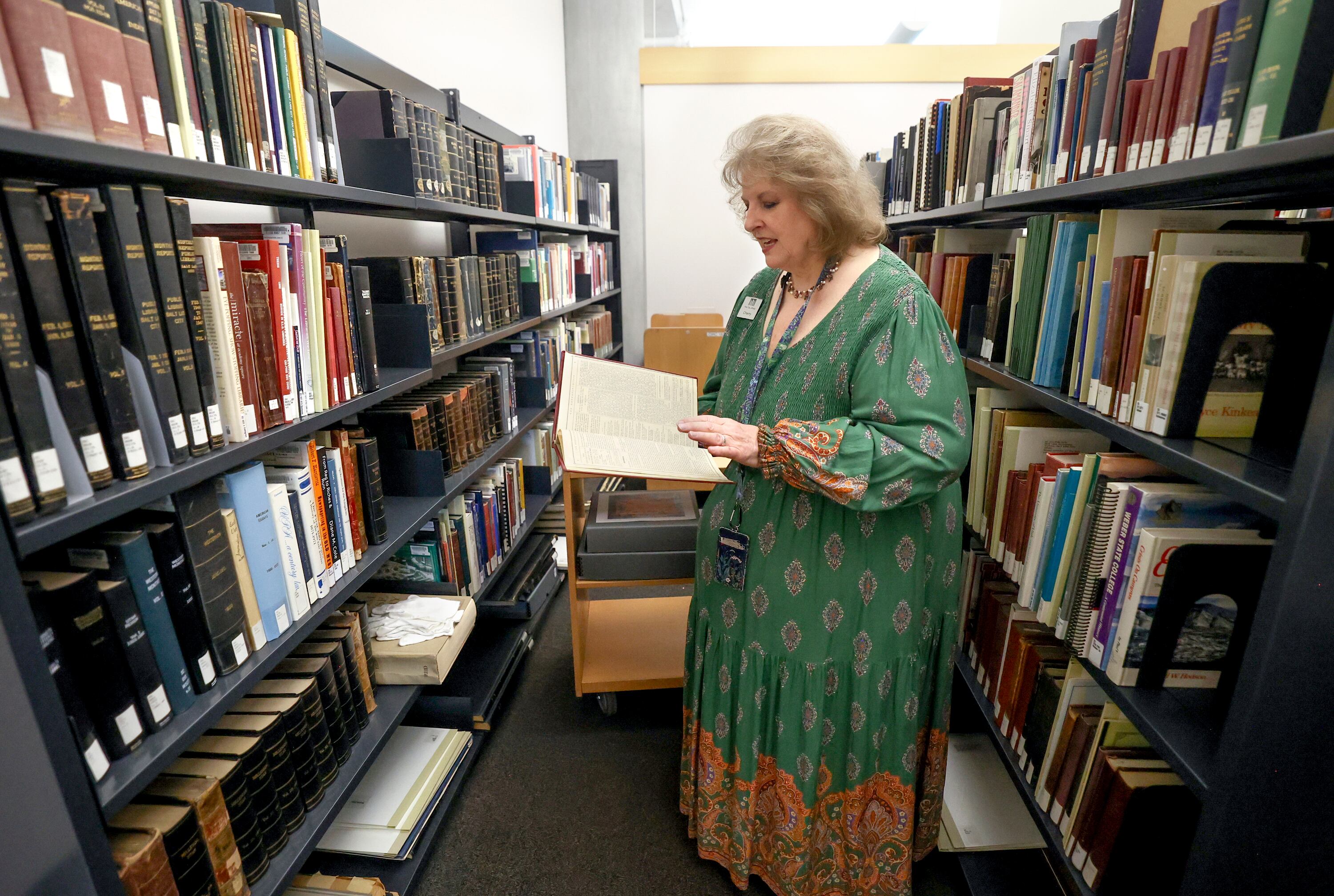 Librarian Cherie Willis shows books kept in the special collections area of the The City Library in Salt Lake City on Aug. 5, 2025.