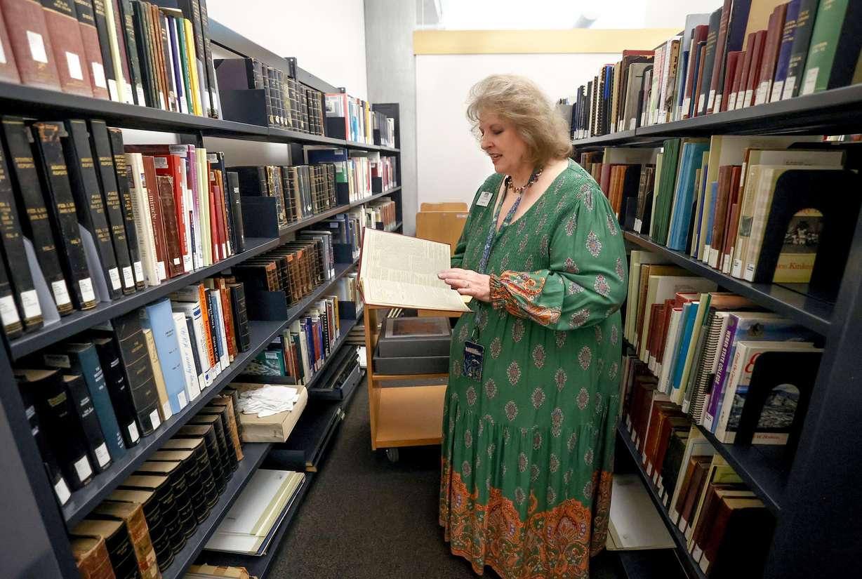 Librarian Cherie Willis shows books kept in the special collections area of the The City Library in Salt Lake City on Aug. 5, 2025.