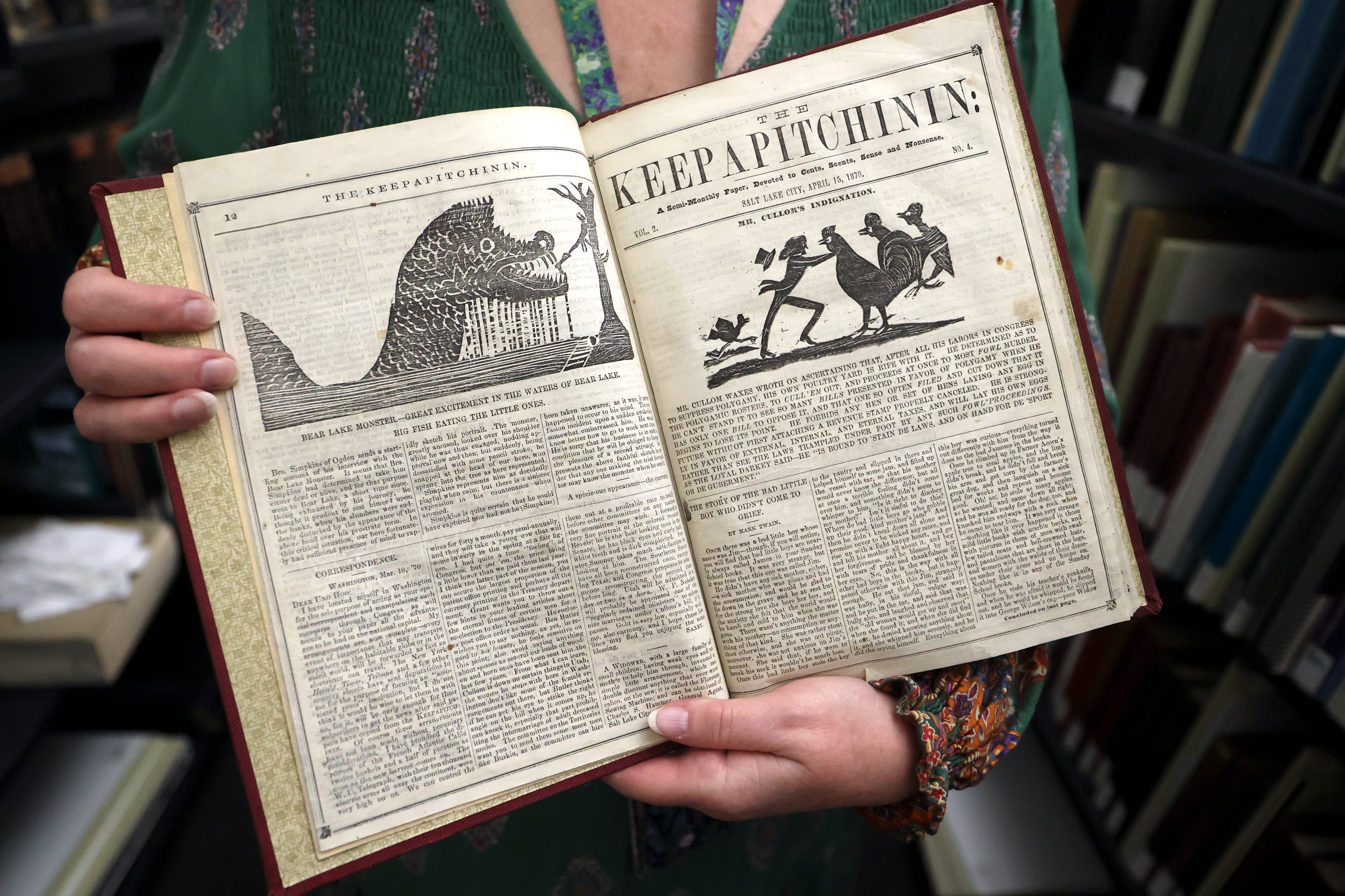 Librarian Cherie Willis shows a 1870 story on the Bear Lake monster from a semi-monthly newspaper called Keepapitchinin in the special collections area of the City Library in Salt Lake City on Aug. 5.