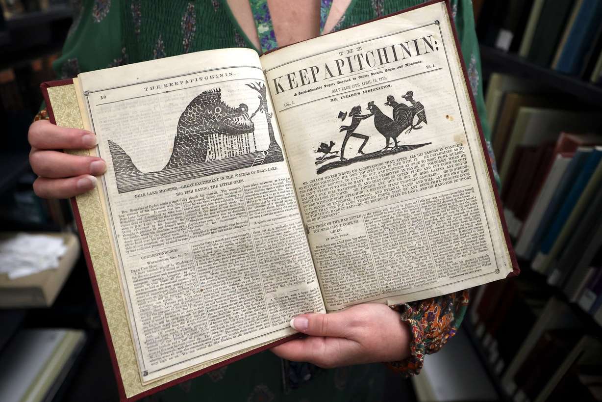 Librarian Cherie Willis shows a 1870 story on the Bear Lake monster from a semi-monthly newspaper called Keepapitchinin in the special collections area of the City Library in Salt Lake City on Aug. 5.