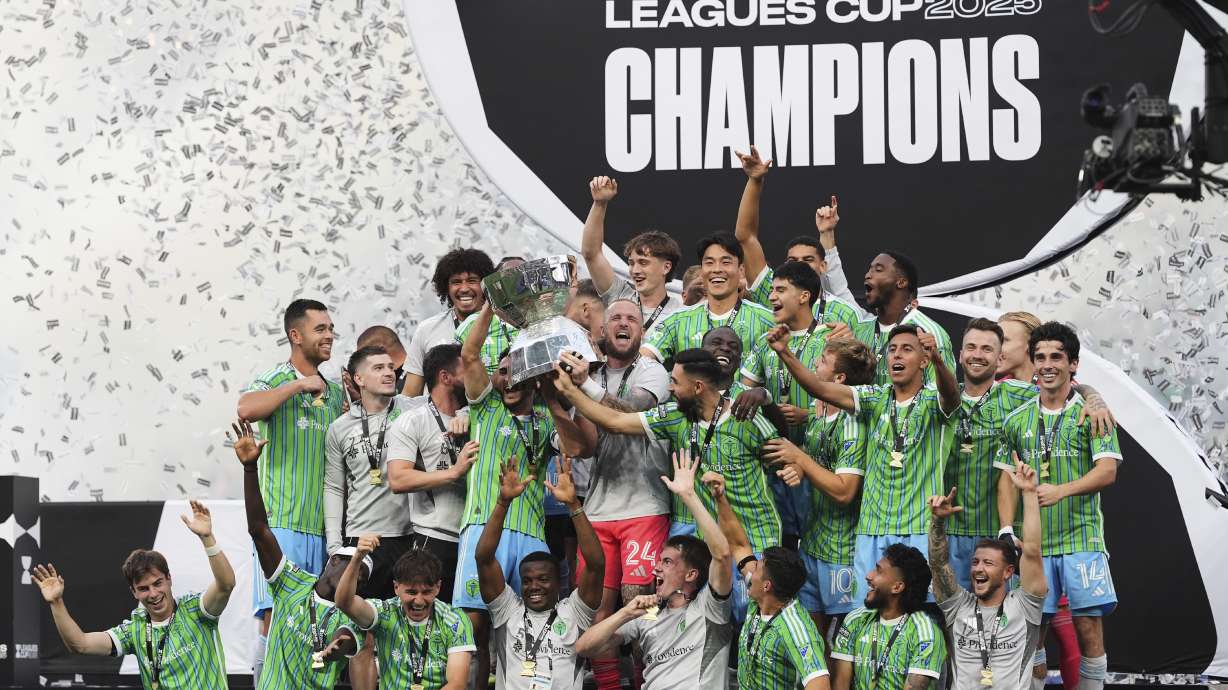 The Seattle Sounders lift the trophy as they celebrate beating Inter Miami in a Leagues Cup final soccer match Sunday, Aug. 31, 2025, in Seattle.