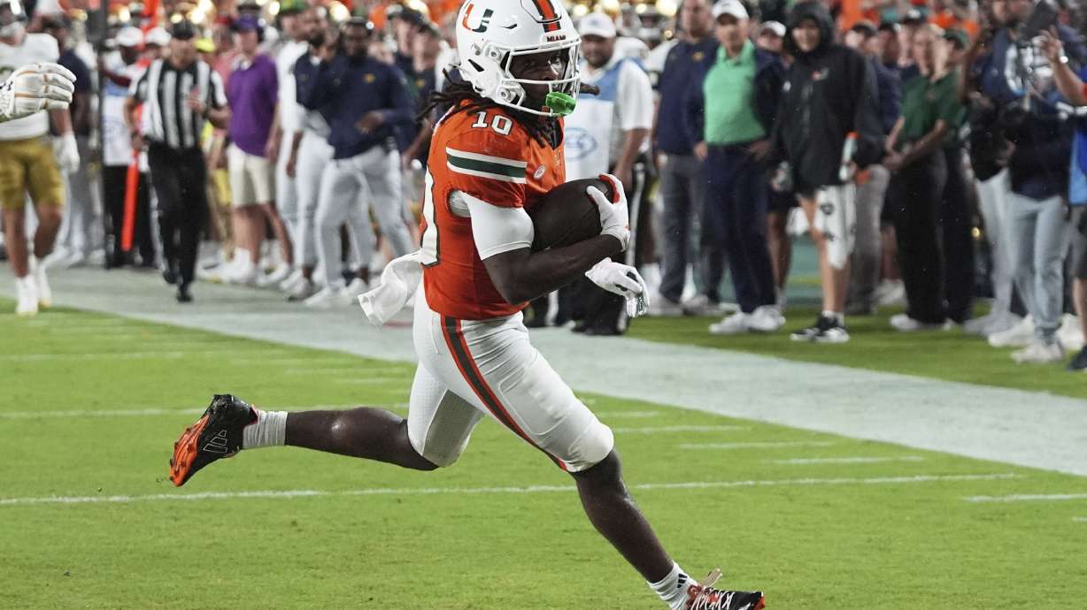 Miami wide receiver Malachi Toney scores a touchdown during the first half of an NCAA college football game against Notre Dame, Sunday, Aug. 31, 2025, in Miami Gardens, Fla.