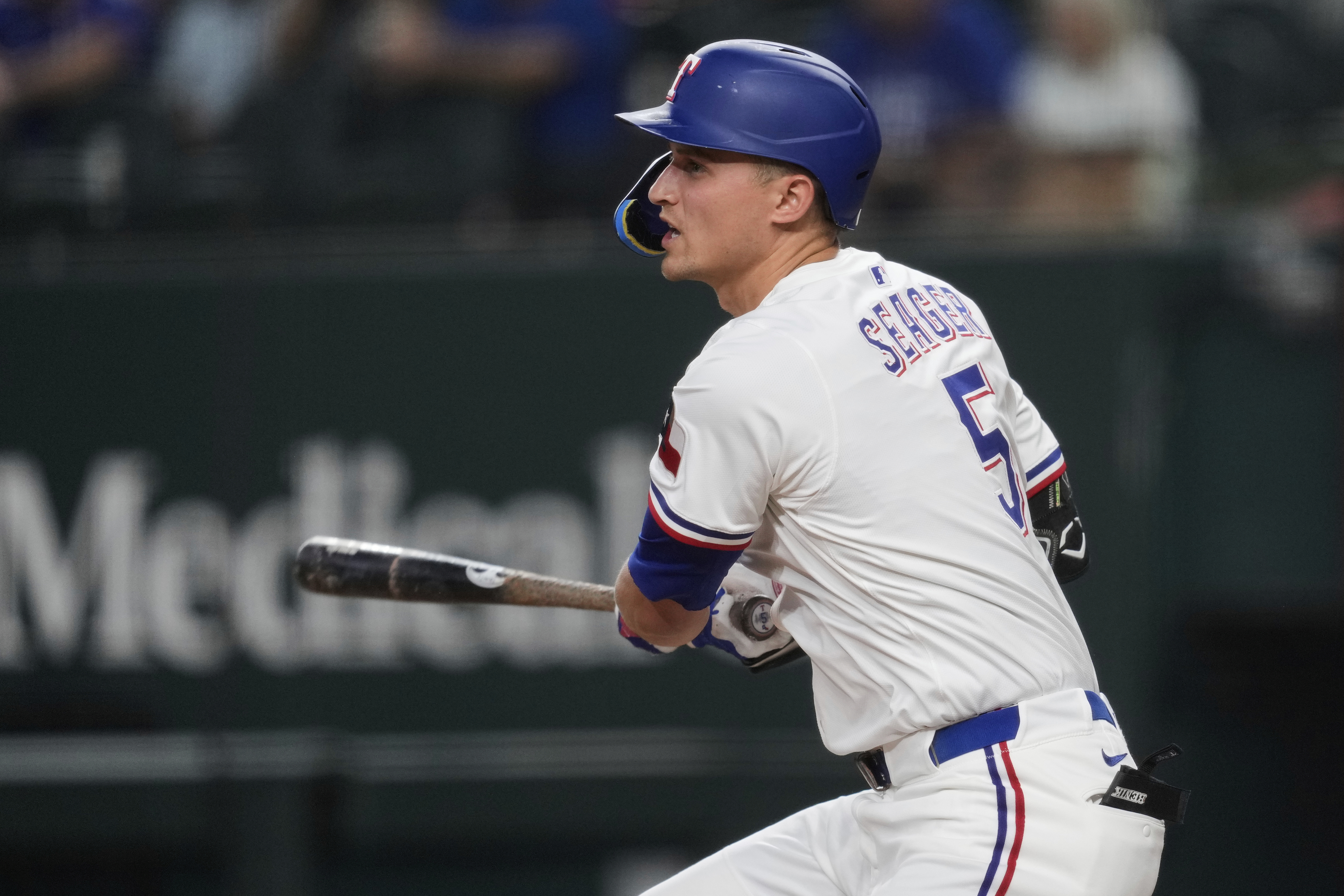 Texas Rangers' Corey Seager follows through on a single in the first inning of a baseball game against the Los Angeles Angels, Wednesday, Aug. 27, 2025, in Arlington, Texas. 