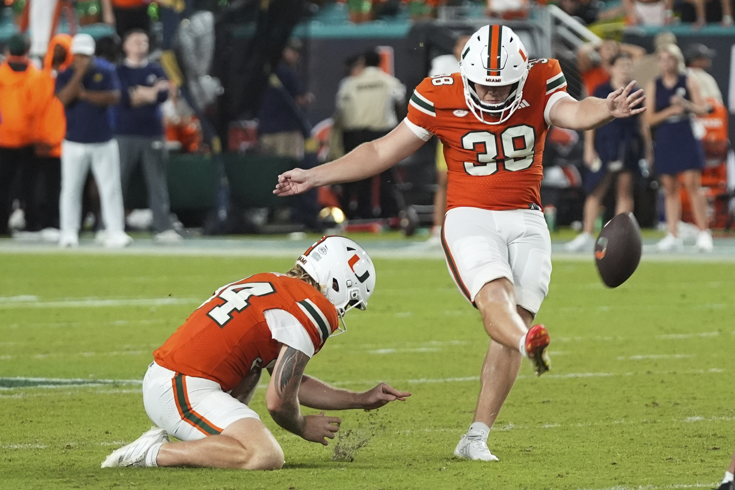 Miami kicker Carter Davis (39) kicks the game winning field goal during the second half of an NCAA college football game against Notre Dame, Sunday, Aug. 31, 2025, in Miami Gardens, Fla. 
