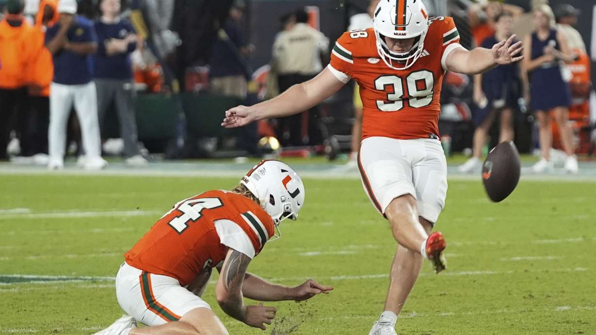Miami kicker Carter Davis (39) kicks the game winning field goal during the second half of an NCAA college football game against Notre Dame, Sunday, Aug. 31, 2025, in Miami Gardens, Fla.