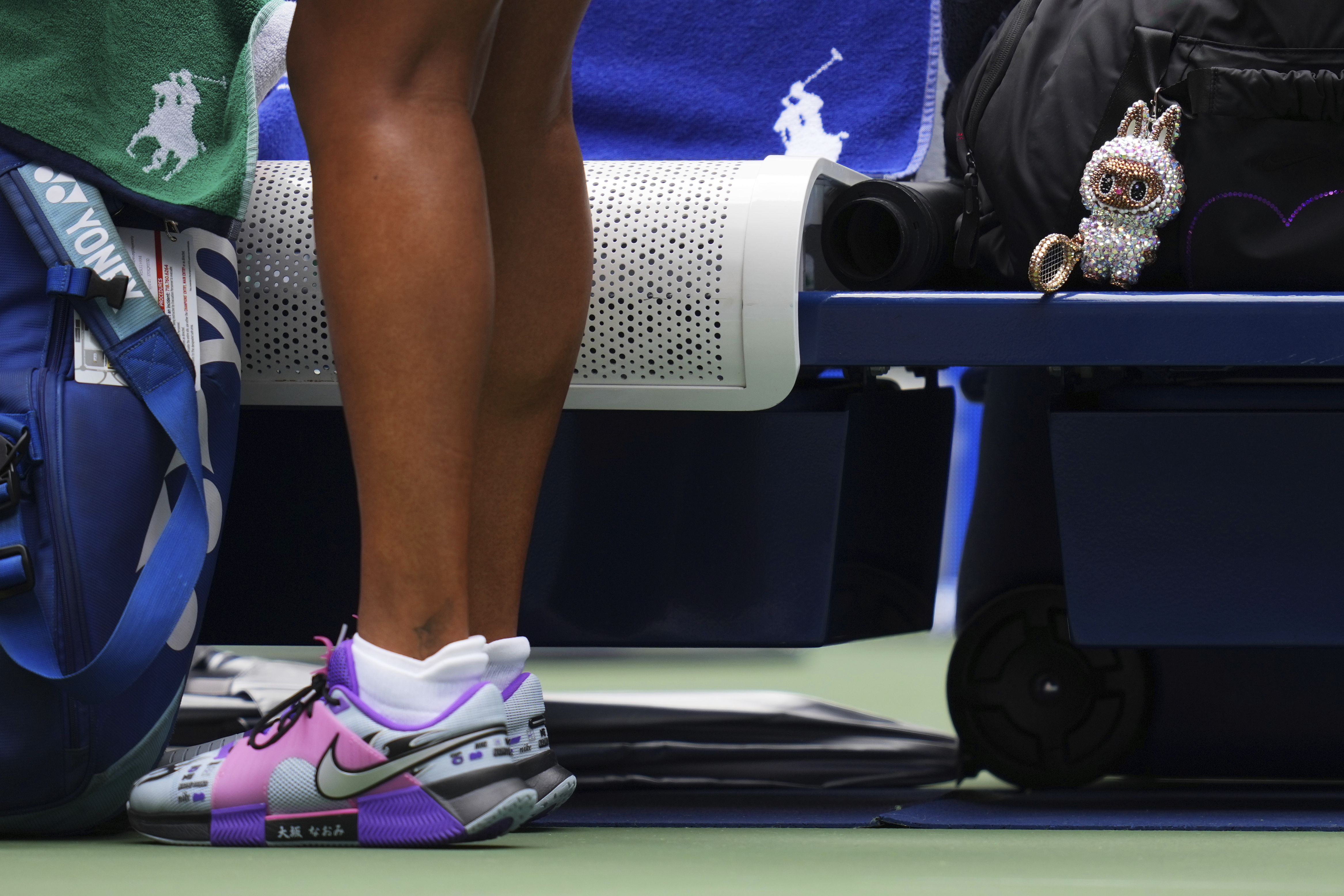 A Labubu doll sits near Naomi Osaka, of Japan, before her match against Coco Gauff, of the United States, during the fourth round of the US Open tennis championships, Monday, Sept. 1, 2025, in New York. 