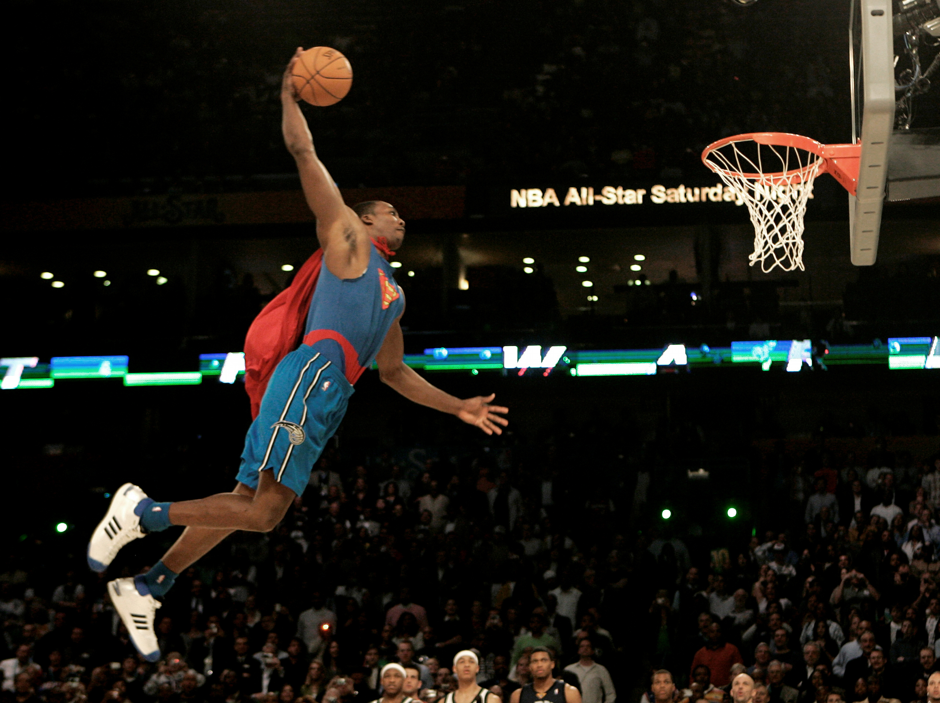 FILE - Wearing a Superman costume, Orlando Magic forward Dwight Howard soars toward the basket in the basketball slam dunk contest Saturday, Feb. 16, 2008, at the NBA All Star Weekend in New Orleans.