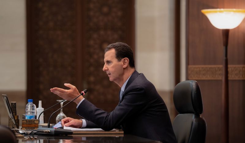 Syria's President Bashar al-Assad speaks as he meets with the Syrian cabinet in Damascus on March 30, 2021. 