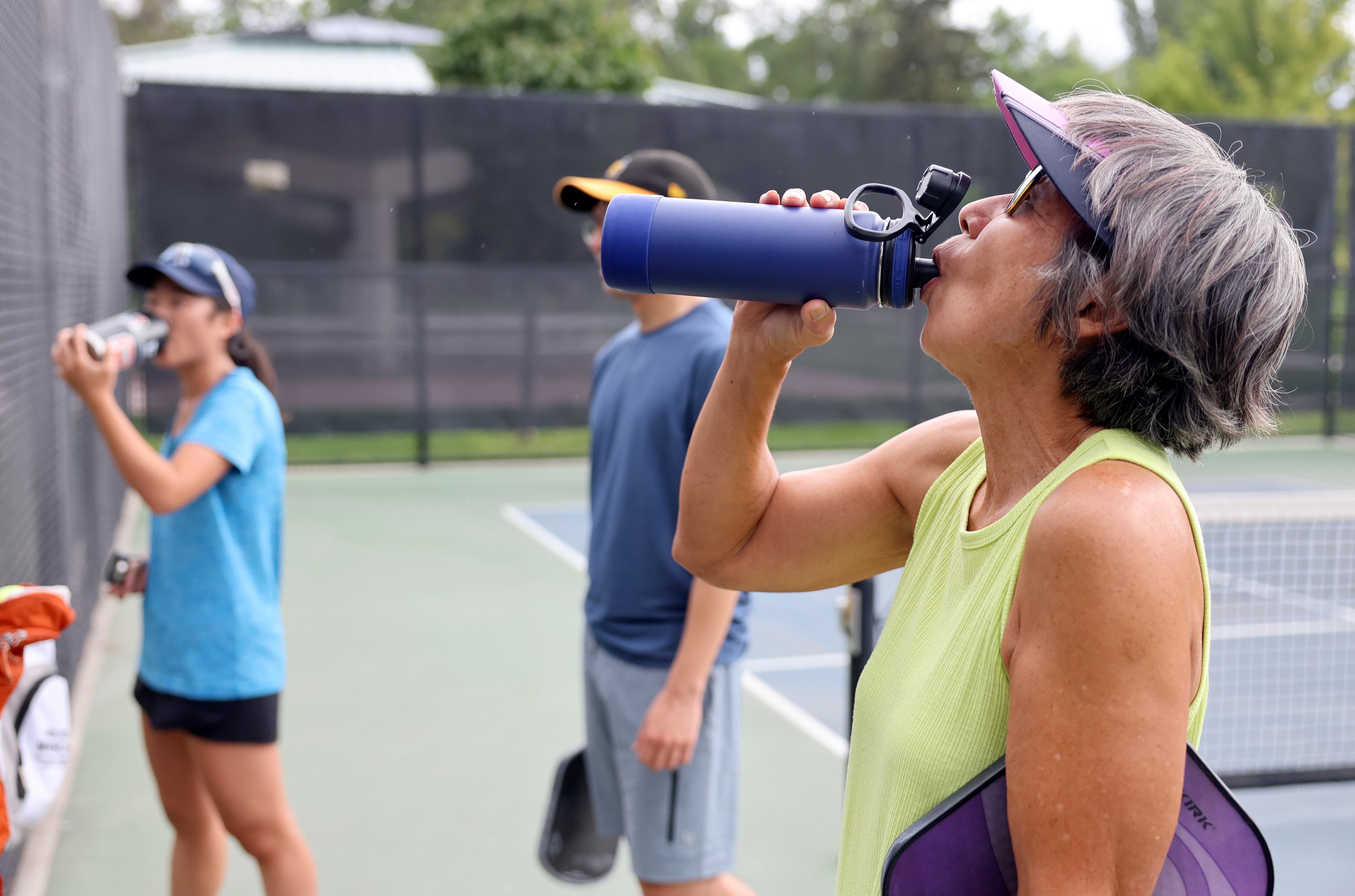 Brenda Koga hydrates between pickleball games at Fairmont Park in Salt Lake City on Aug. 26. Koga said she tries to "play smart."