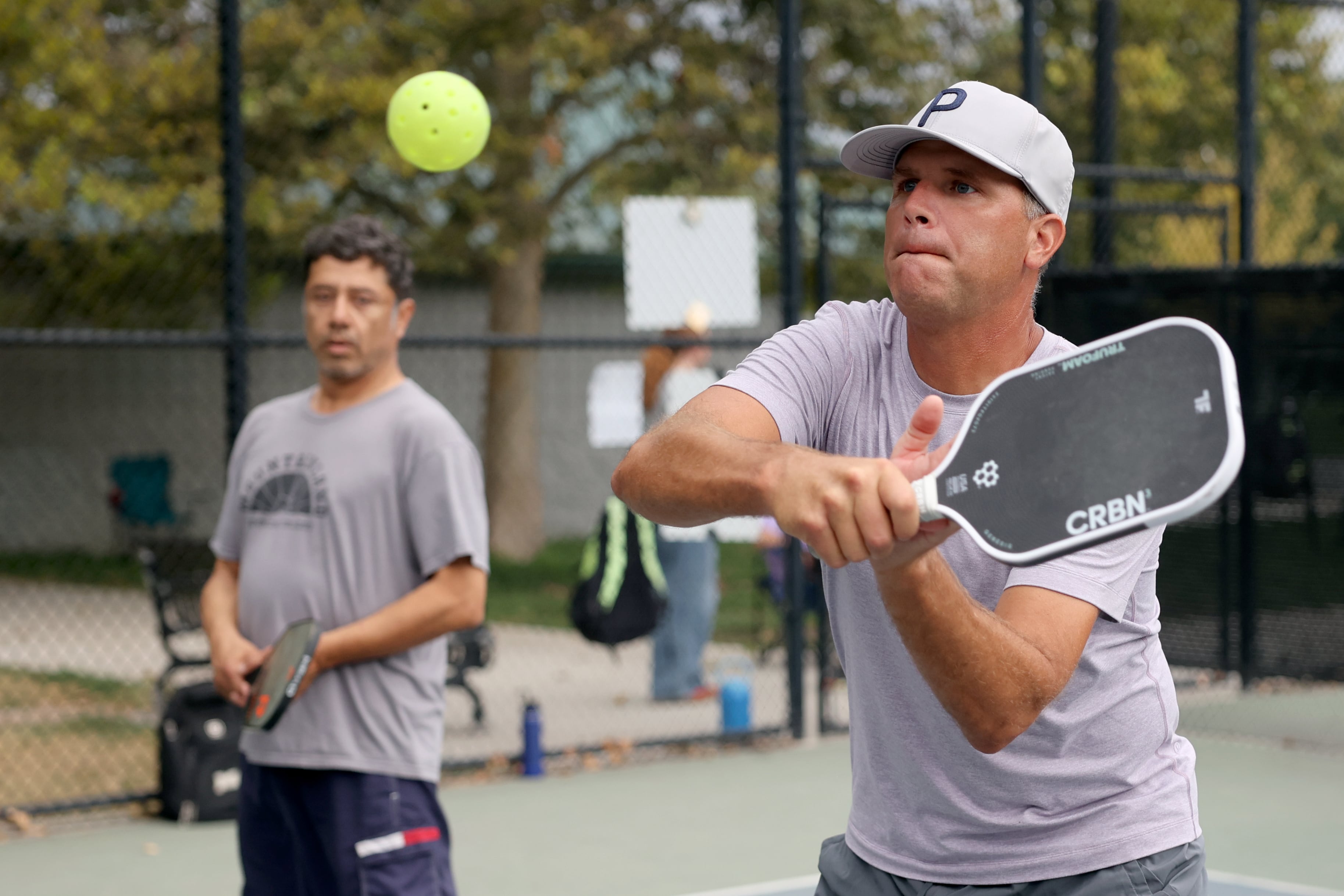 Chad Oberson and Johnny Garcia play pickleball at Fairmont Park in Salt Lake City on Aug. 26. Learning correct technique and wearing proper footwear can help prevent injuries.
