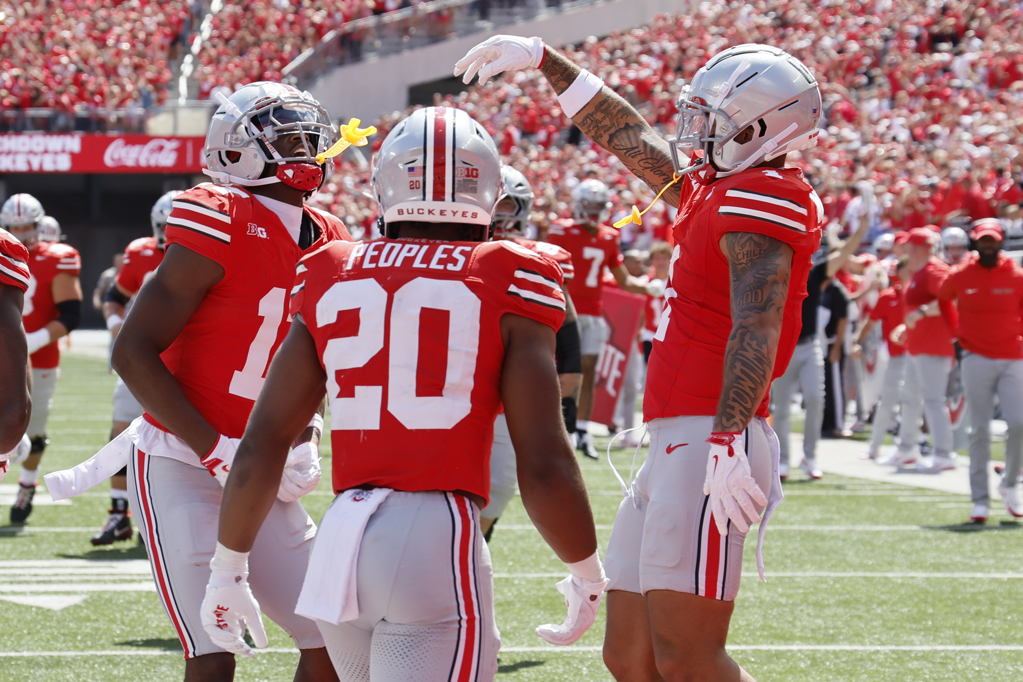 Ohio State receiver Carnell Tate, left, celebrates his touchdown against Texas during the second half of an NCAA college football game, Saturday, Aug. 30, 2025, in Columbus, Ohio.