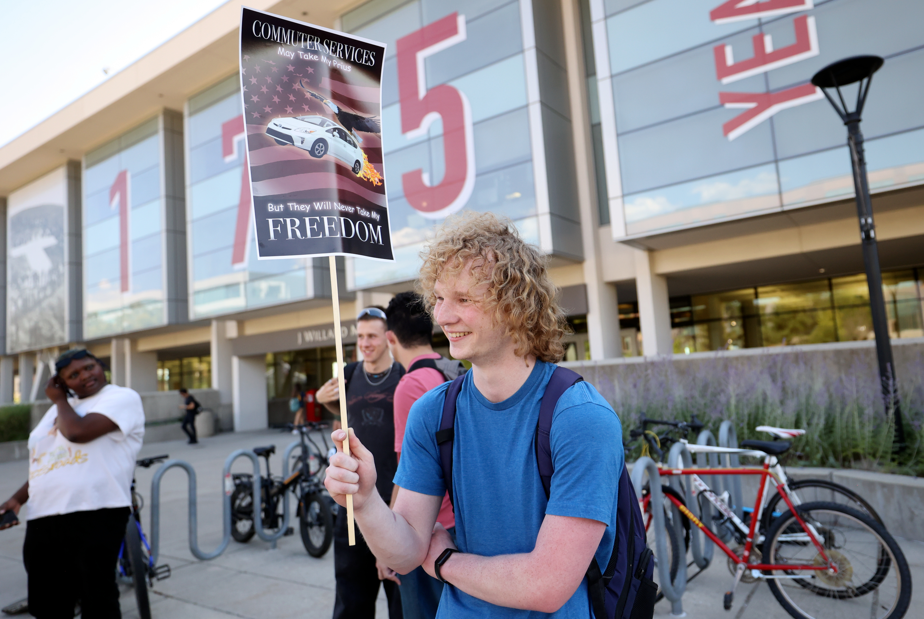 University of Utah senior Adam Stringham holds a sign at a small protest about parking changes outside of the Marriott Library at the University of Utah in Salt Lake City on Tuesday. Recently announced changes regarding class scheduling at the U. have led to a social media firestorm and significant student pushback.