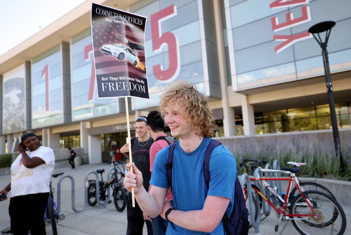 University of Utah senior Adam Stringham holds a sign at a small protest about parking changes outside of the Marriott Library at the University of Utah in Salt Lake City on Tuesday. Recently announced changes regarding class scheduling at the U. have led to a social media firestorm and significant student pushback.