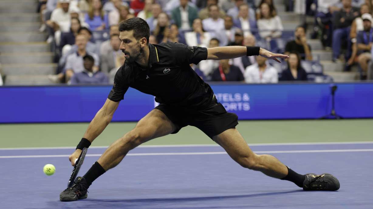 Novak Djokovic, of Serbia, returns a shot against Taylor Fritz, of the United States, during the quarterfinal round of the U.S. Open tennis championships, Tuesday, Sept. 2, 2025, in New York.