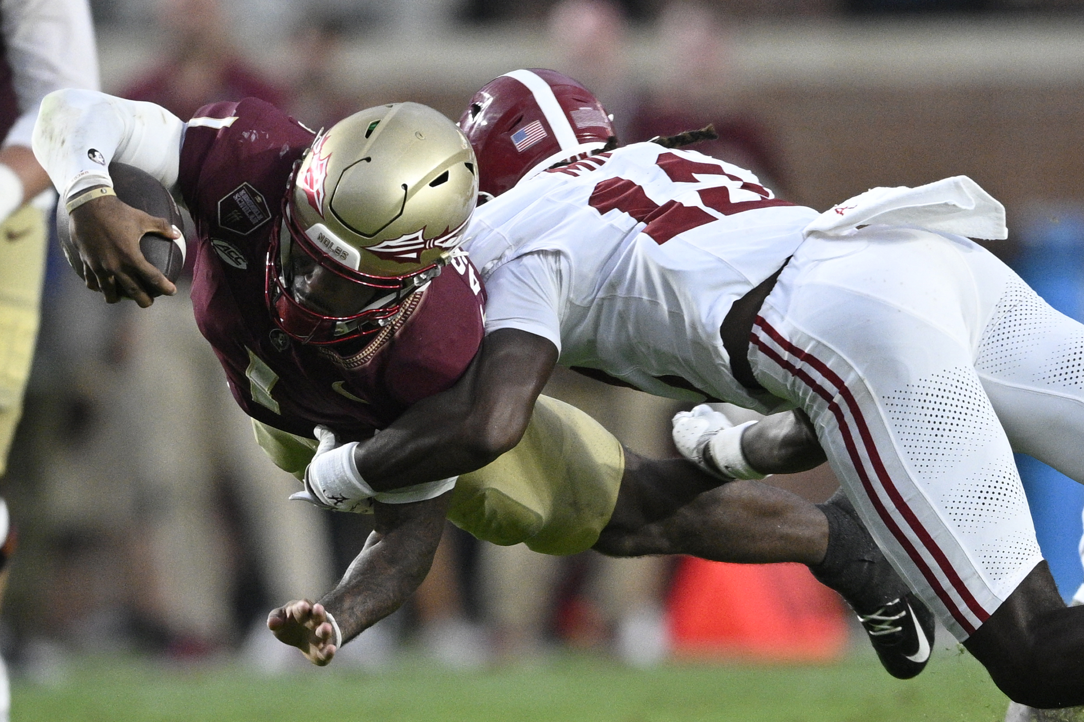 Florida State quarterback Tommy Castellanos (1) dives for extra yardage as Alabama defensive back Zavier Mincey (12) makes the tackle during the second half of an NCAA college football game, Saturday, Aug. 30, 2025, in Tallahassee, Fla. 