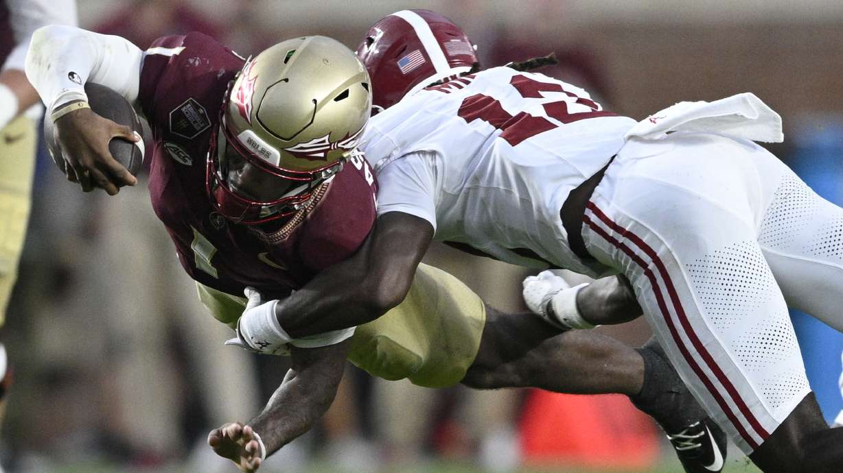 Florida State quarterback Tommy Castellanos (1) dives for extra yardage as Alabama defensive back Zavier Mincey (12) makes the tackle during the second half of an NCAA college football game, Saturday, Aug. 30, 2025, in Tallahassee, Fla.